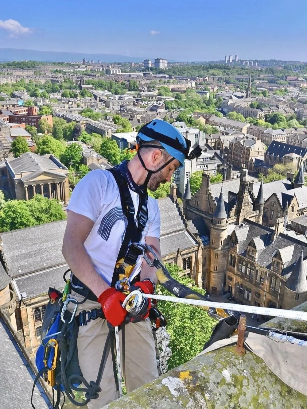 Rope access person on ropes on tower in Glasgow.