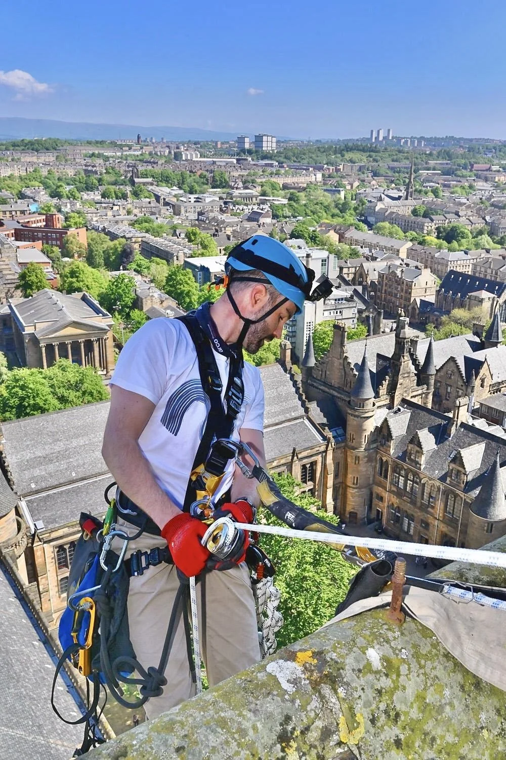 Rope access technician abseiling off a steeple