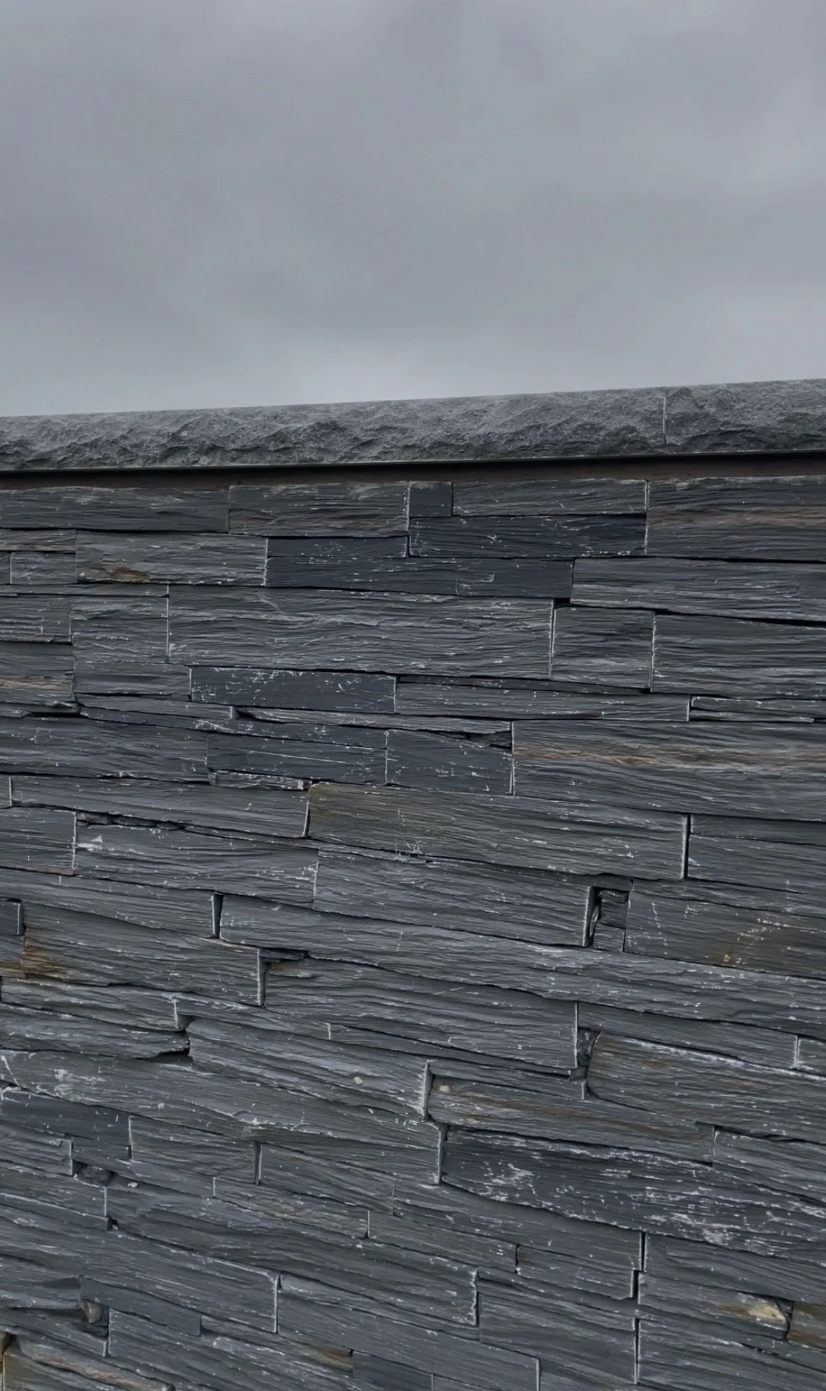 Kilkenny Limestone Copings with dressed edge on top of a Welsh slate walling