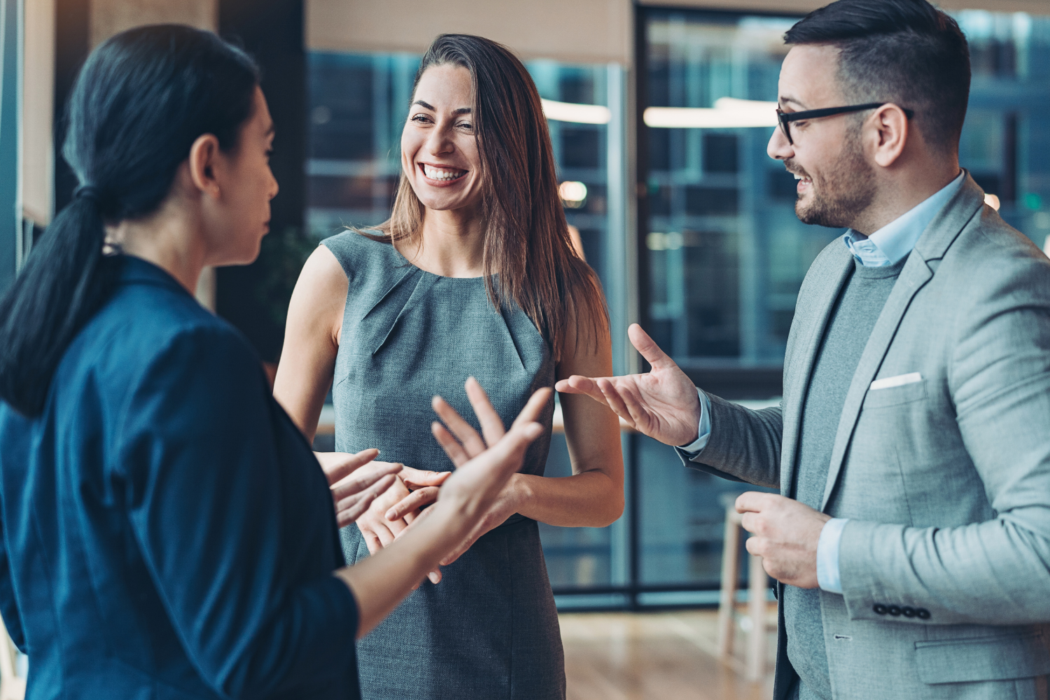 Three people networking and smiling