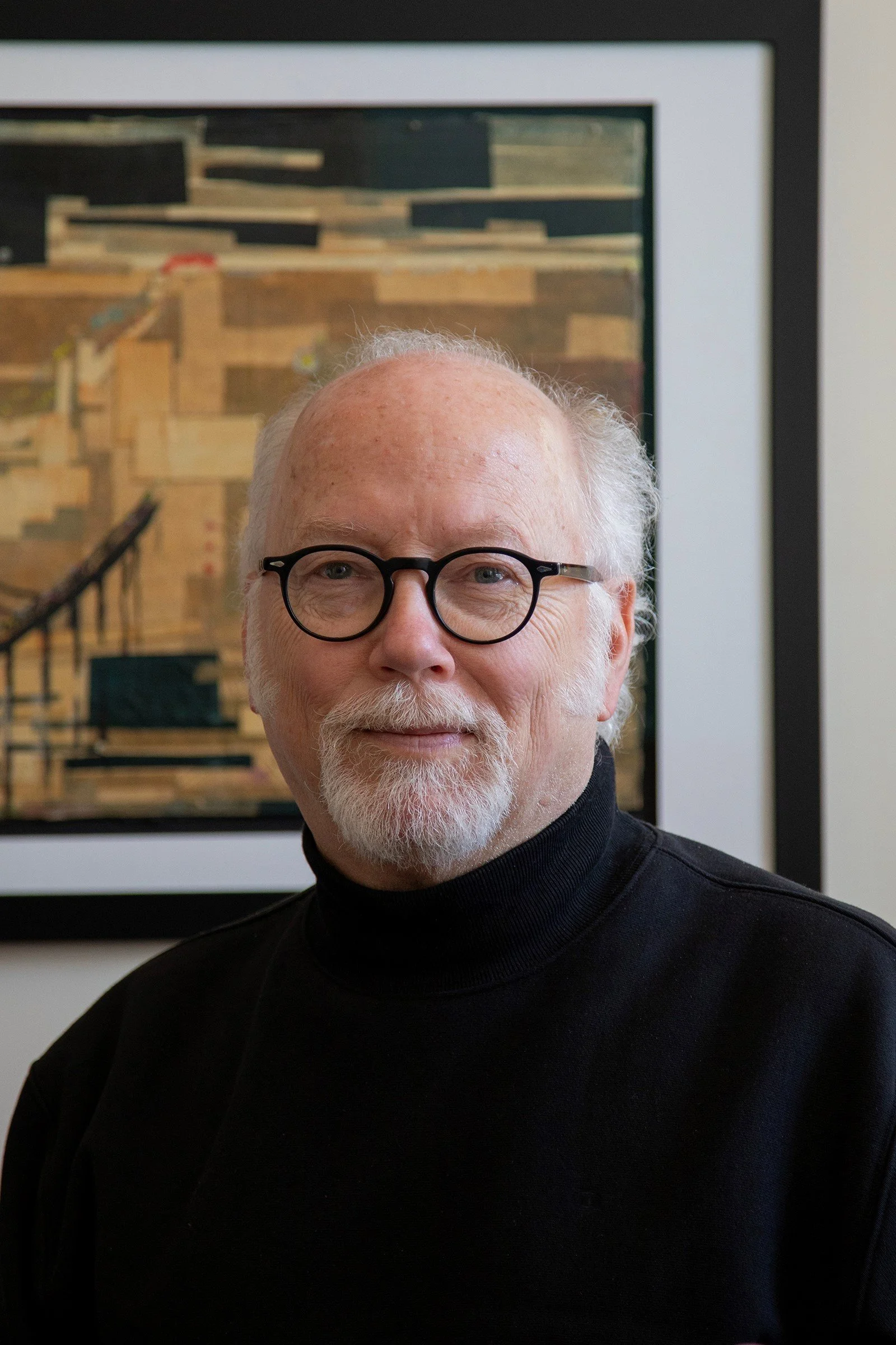 Ornate stained glass window with geometric and floral patterns, featuring colors like purple, blue, and brown.