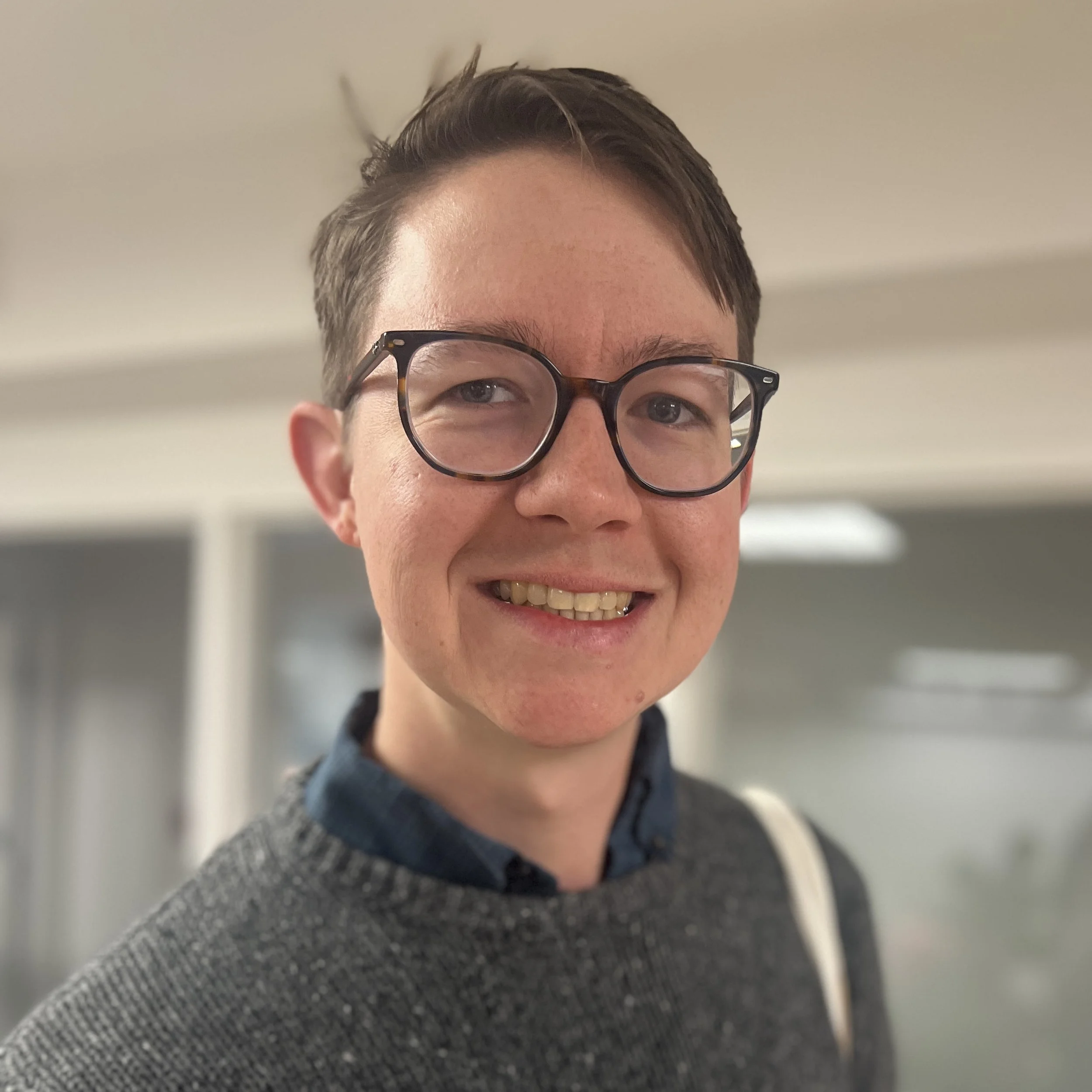 Portrait of a man in a suit and tie with a smiling expression.