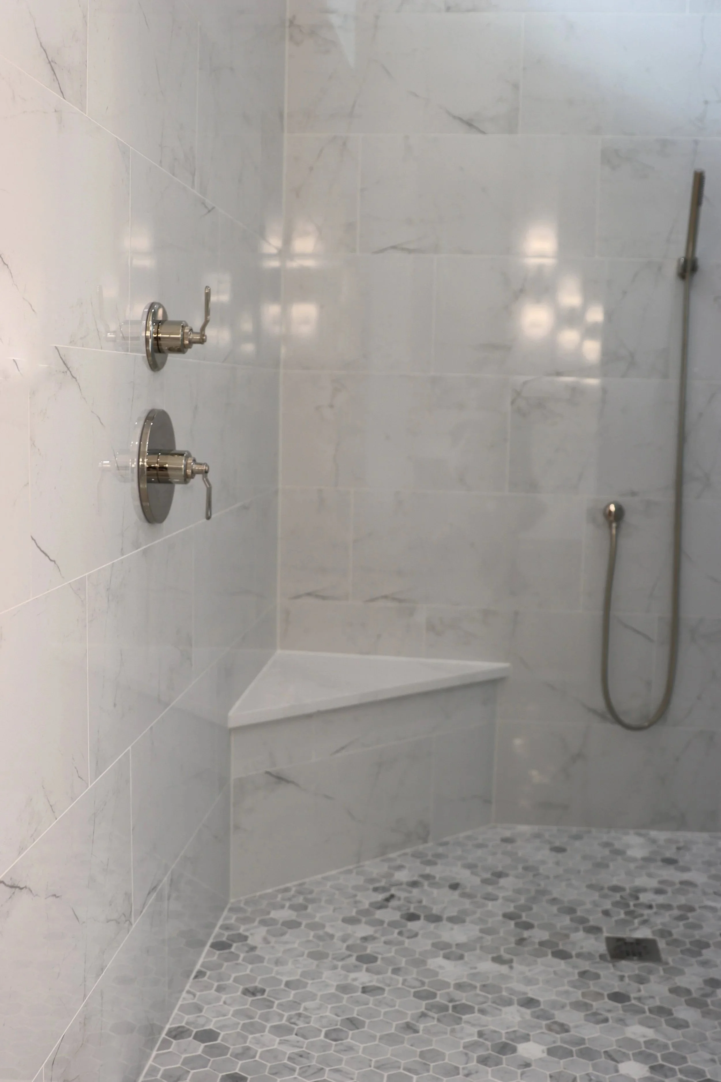 Marble tile walk in shower with bench Jacksonville FL.jpg
