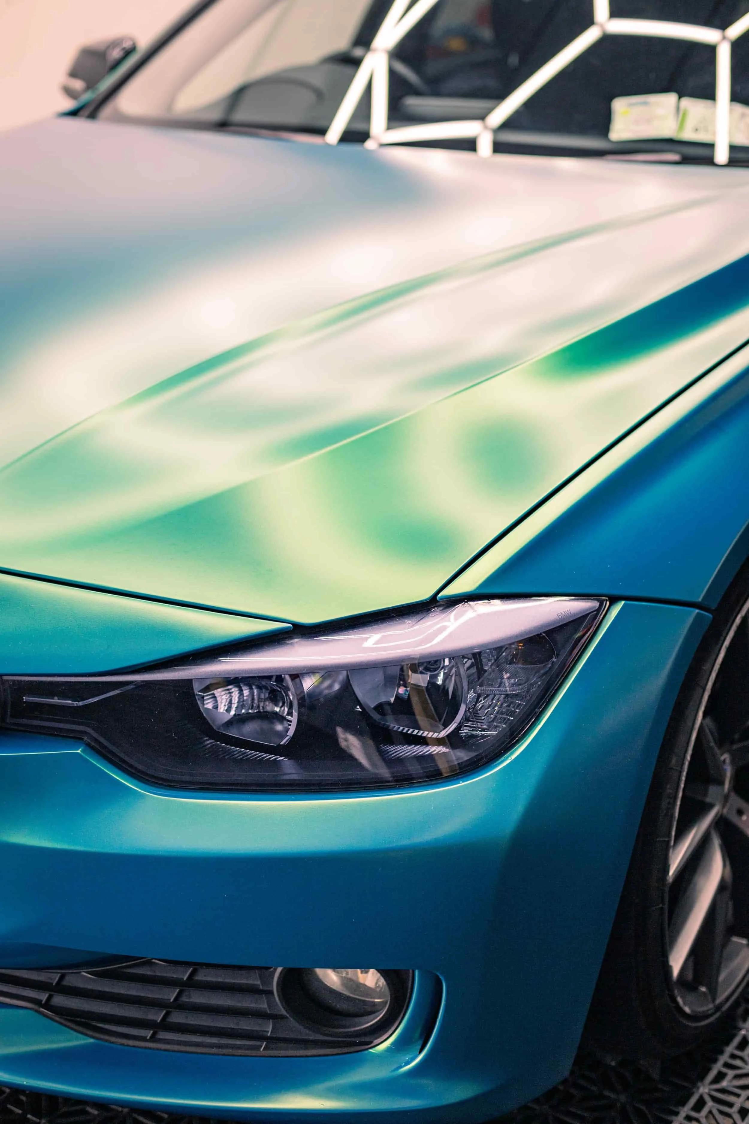 Picture of a teal car ceramic coated in our 3 year coating