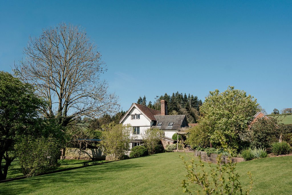 Redford Farm Stays self caterin accommodation main Farmhouse on sunny days overlookin the upper lawn.