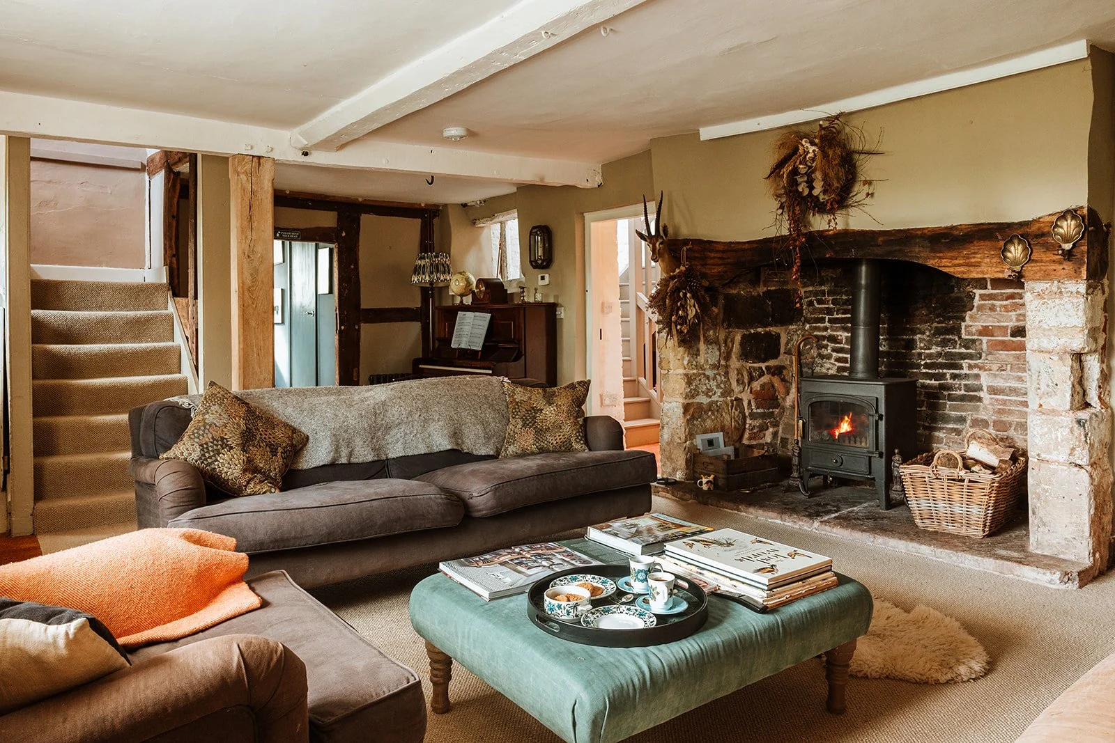 Redford Farm Stays farmhouse living area view with stairs and fire