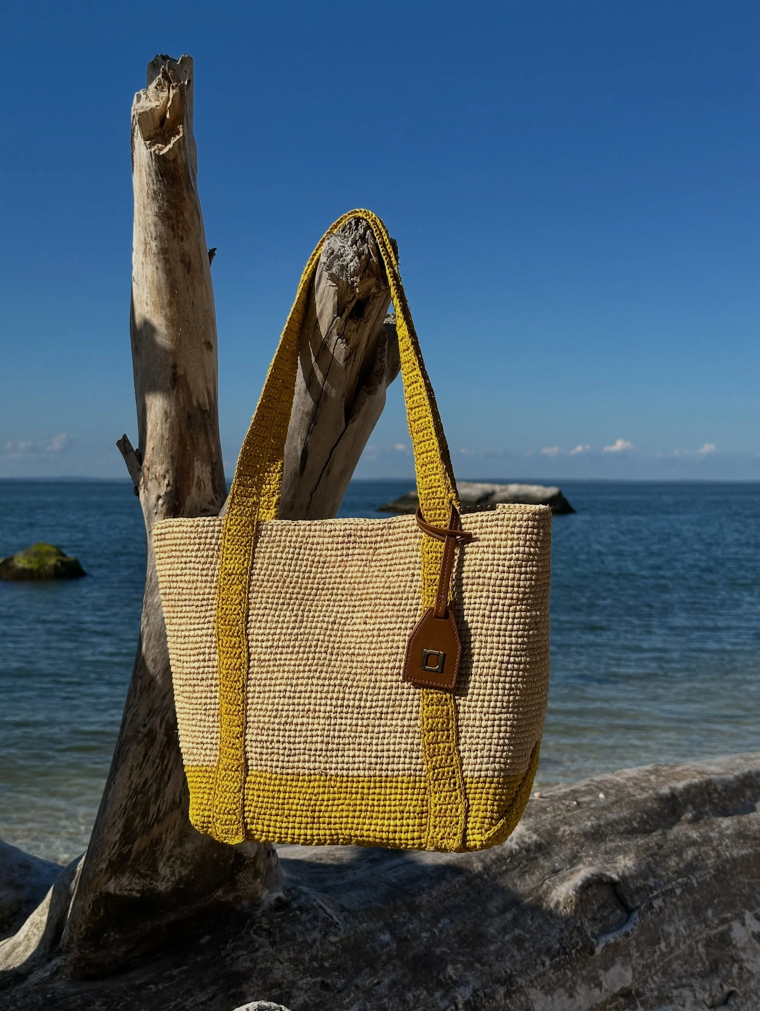 #CanITellYou&hellip; summer is still in season. ☀️
The RAFE Boat Tote in natural and lemon yellow raffia&mdash;sunny, effortless, and made for weekends by the water.
From city days to seaside escapes, consider this your carry-everywhere bag for the r