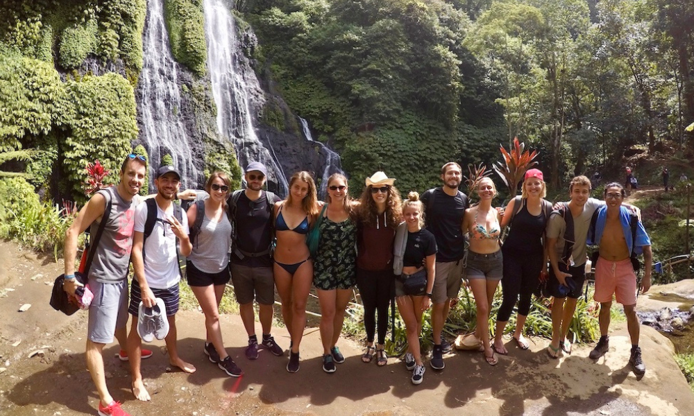 sober friends in bali in front of a waterfall