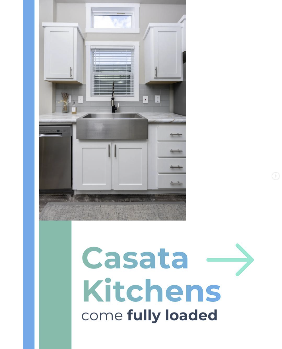 Casata instagram post A modern kitchen with white cabinets, a stainless steel farmhouse sink, a window with blinds, and various kitchen items on the countertop.
