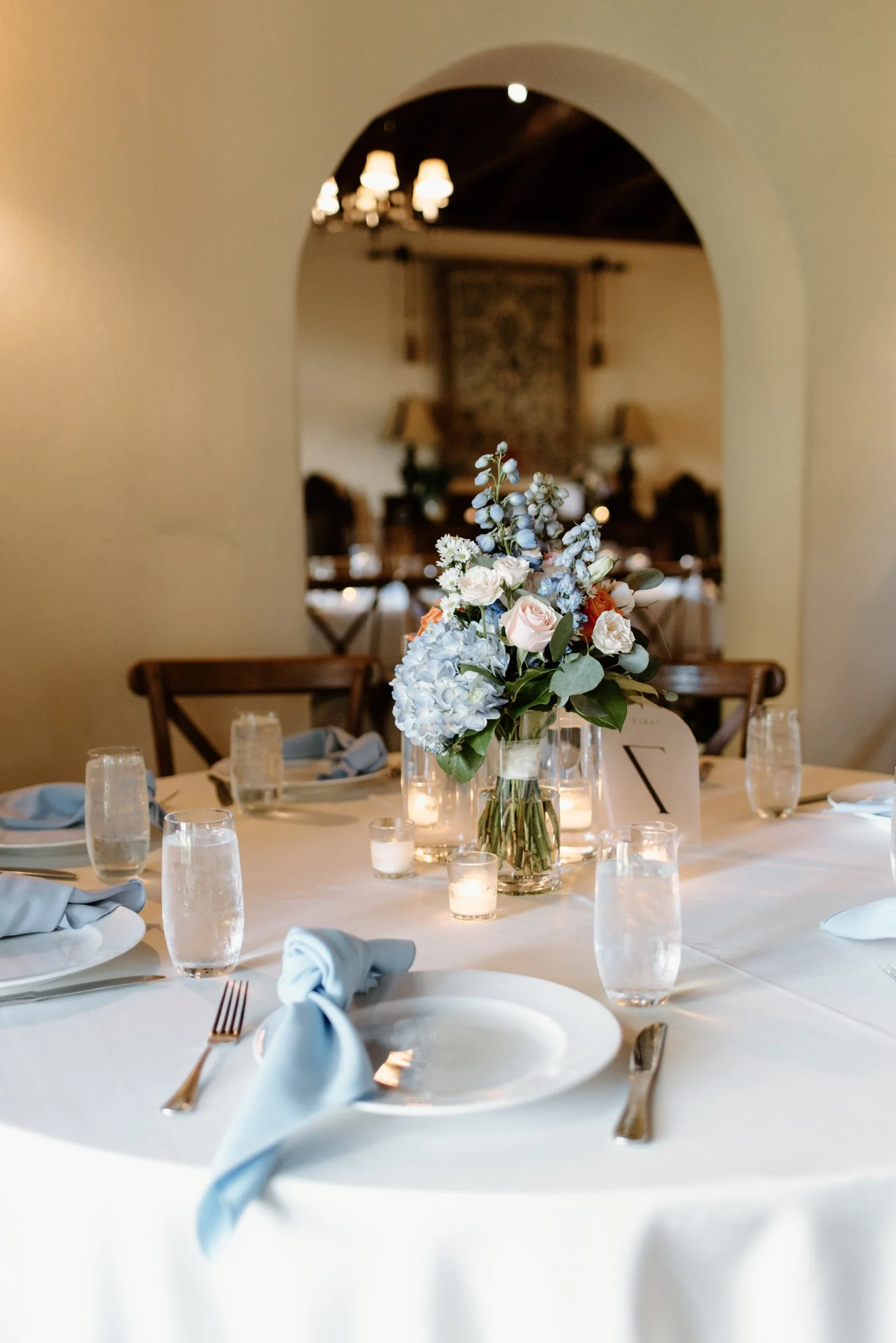 Indoor dinner spread at Casa Feliz, Winter Park, historic rooms and warm candlelight creating a cozy rainy day reception (Joanna Moore Photography).	