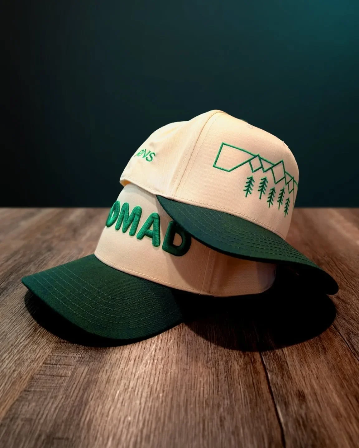 Pick your perspective. 🏔️

​Bold and unapologetic or subtle and nature-driven? Our newest hats feature a cream crown and a deep forest-green brim&mdash;the perfect palette for those who feel at home under the canopy.

​The Nomad Puff 5-Panel: For th