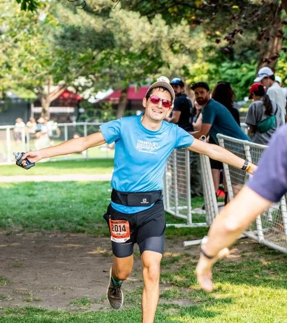 An elated Ian with his arms outstretched finishing the Squamish 50 Mile race