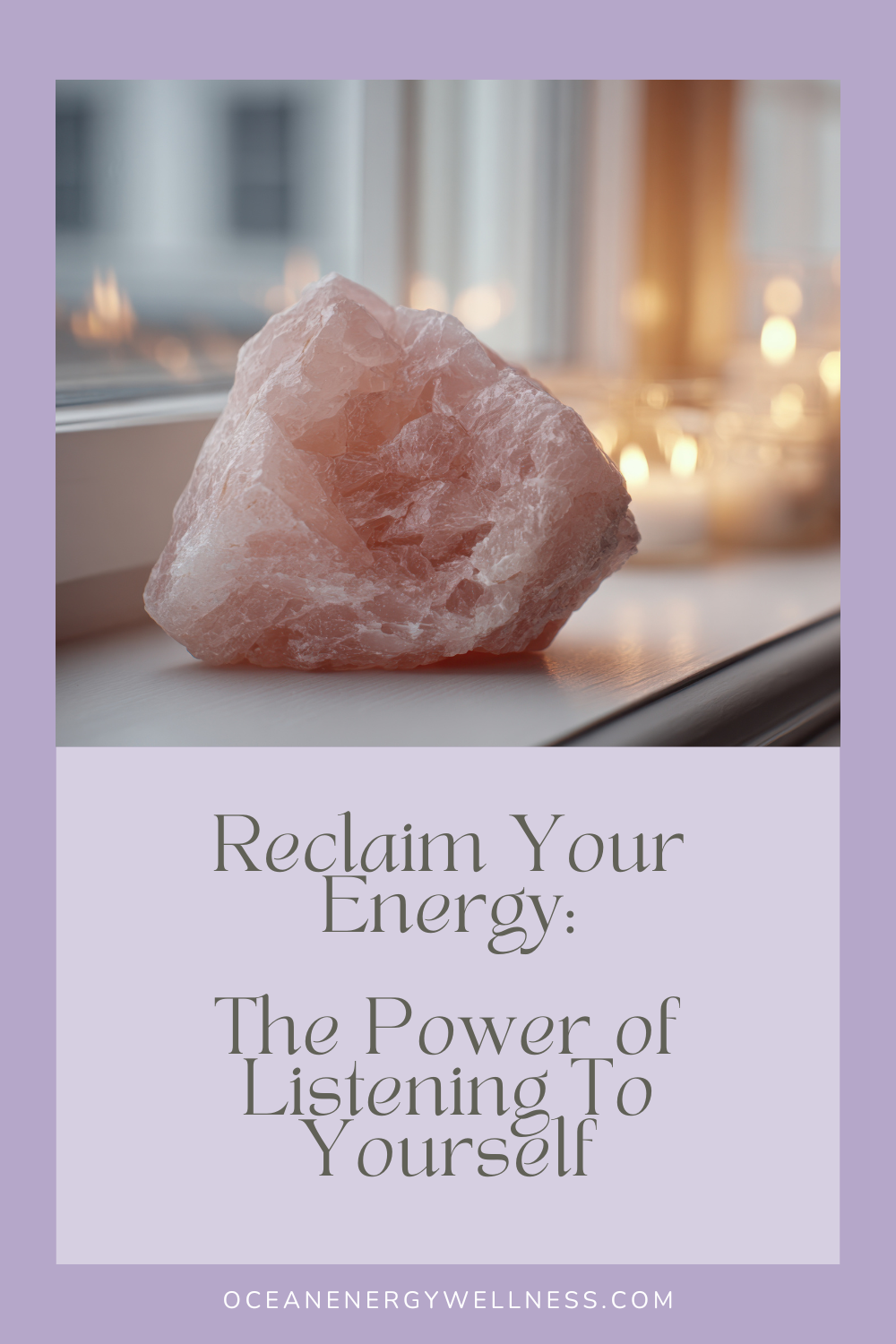 rose quartz crystal sitting on widow sill with candles in the background