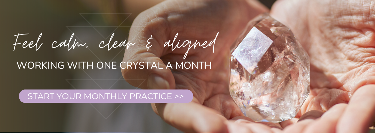 woman holding a clear quartz crystal in hand text about a monthly crystal practice