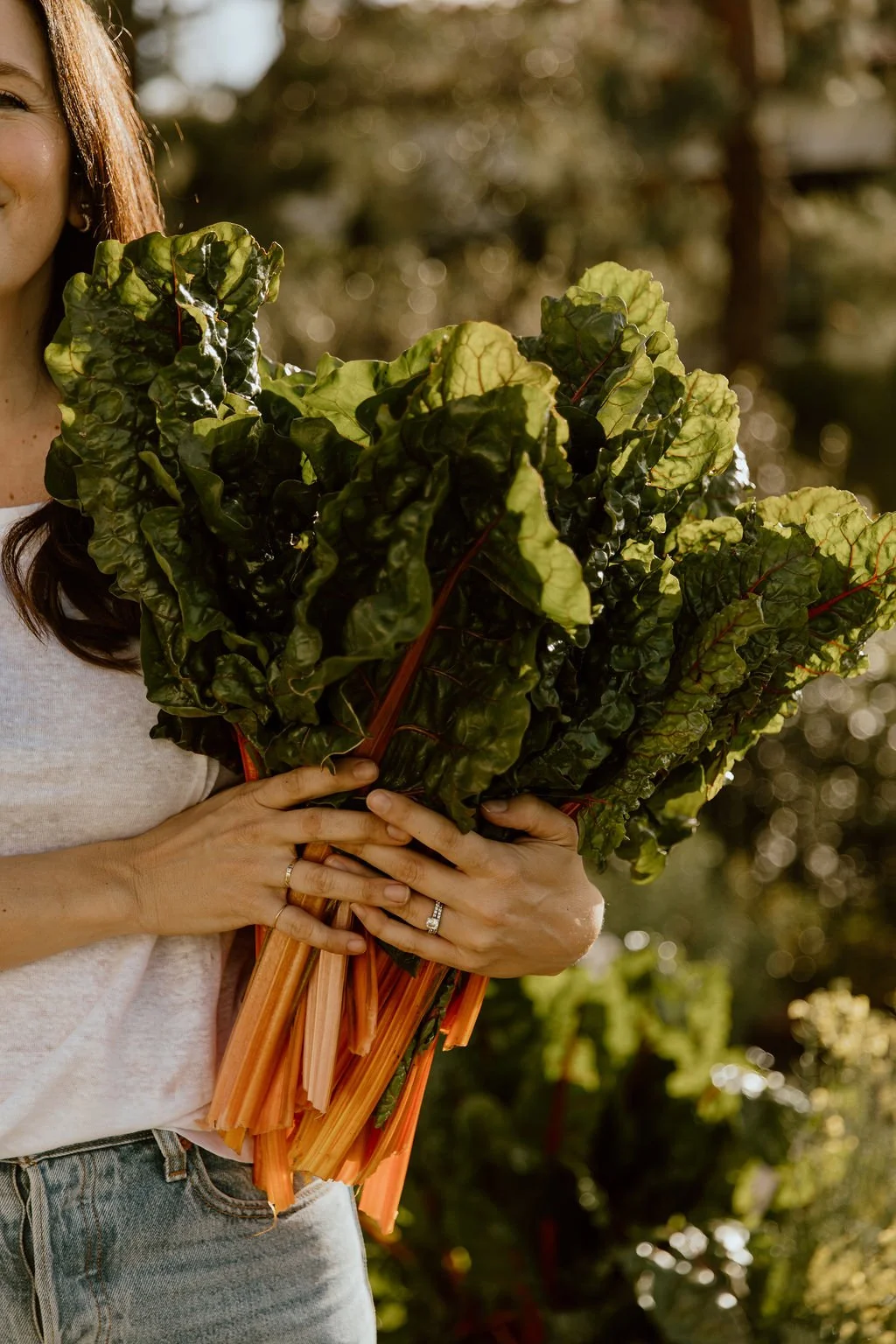woman holding rainbow chard
