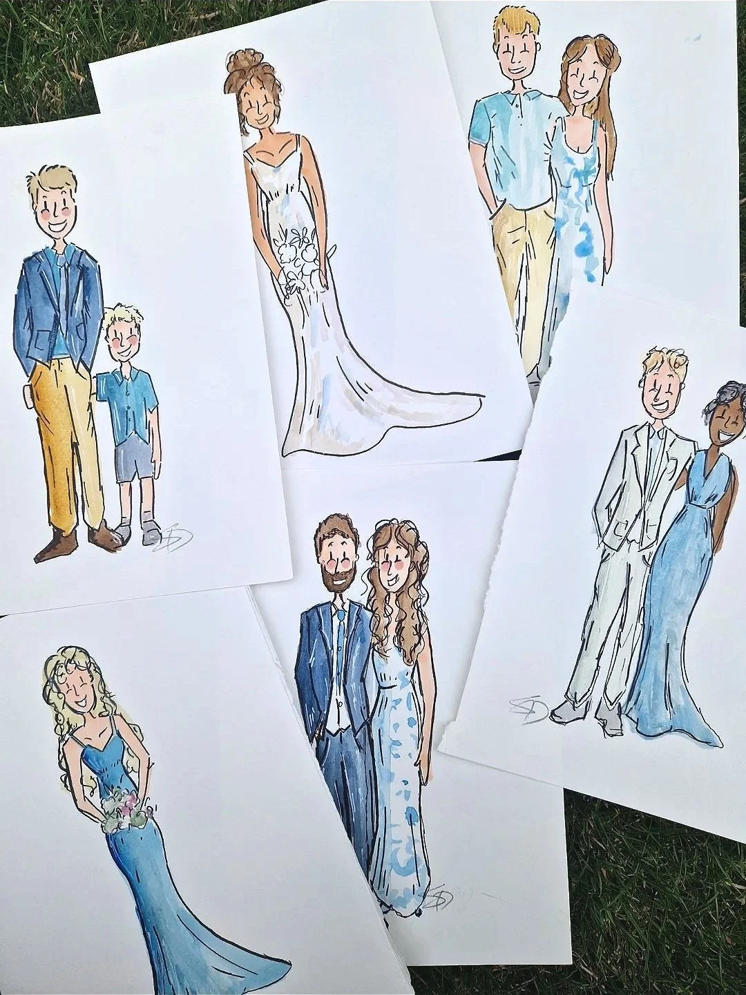 Wedding invitation cards featuring floral illustrations, a dog, and illustrations of a couple, with pink and brown ribbons on a wooden surface.