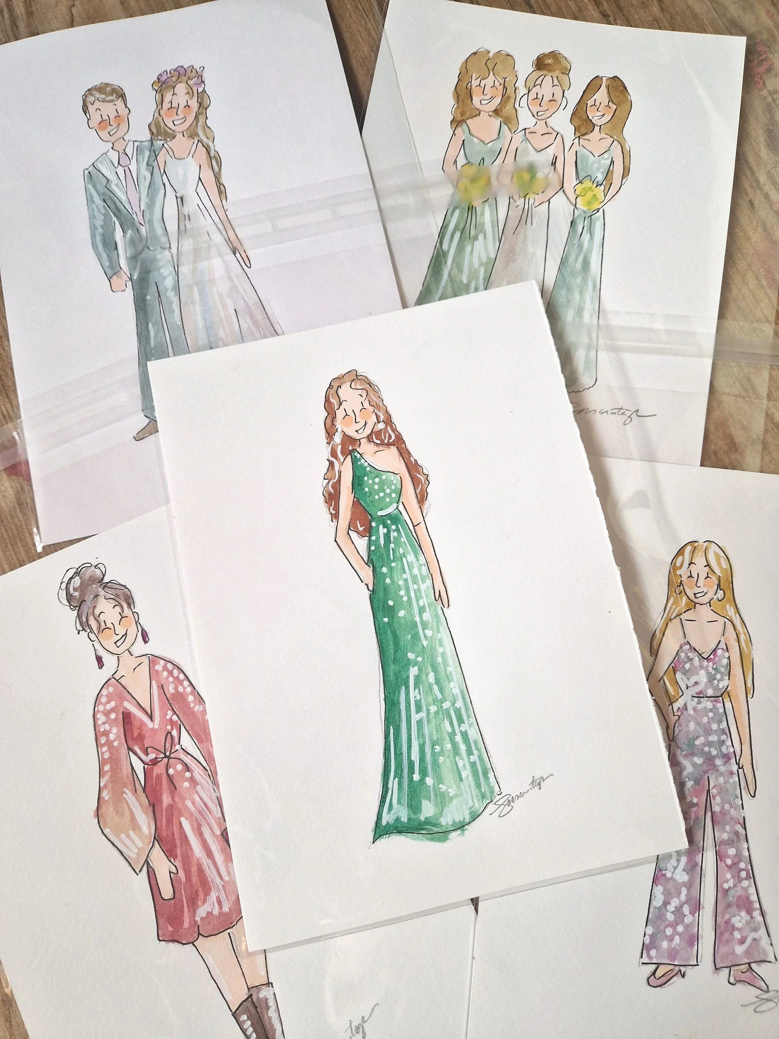 Wedding invitation and RSVP card for Charlie and Bex, decorated with a colorful floral wreath, placed on a wooden surface with green leafy decorations.