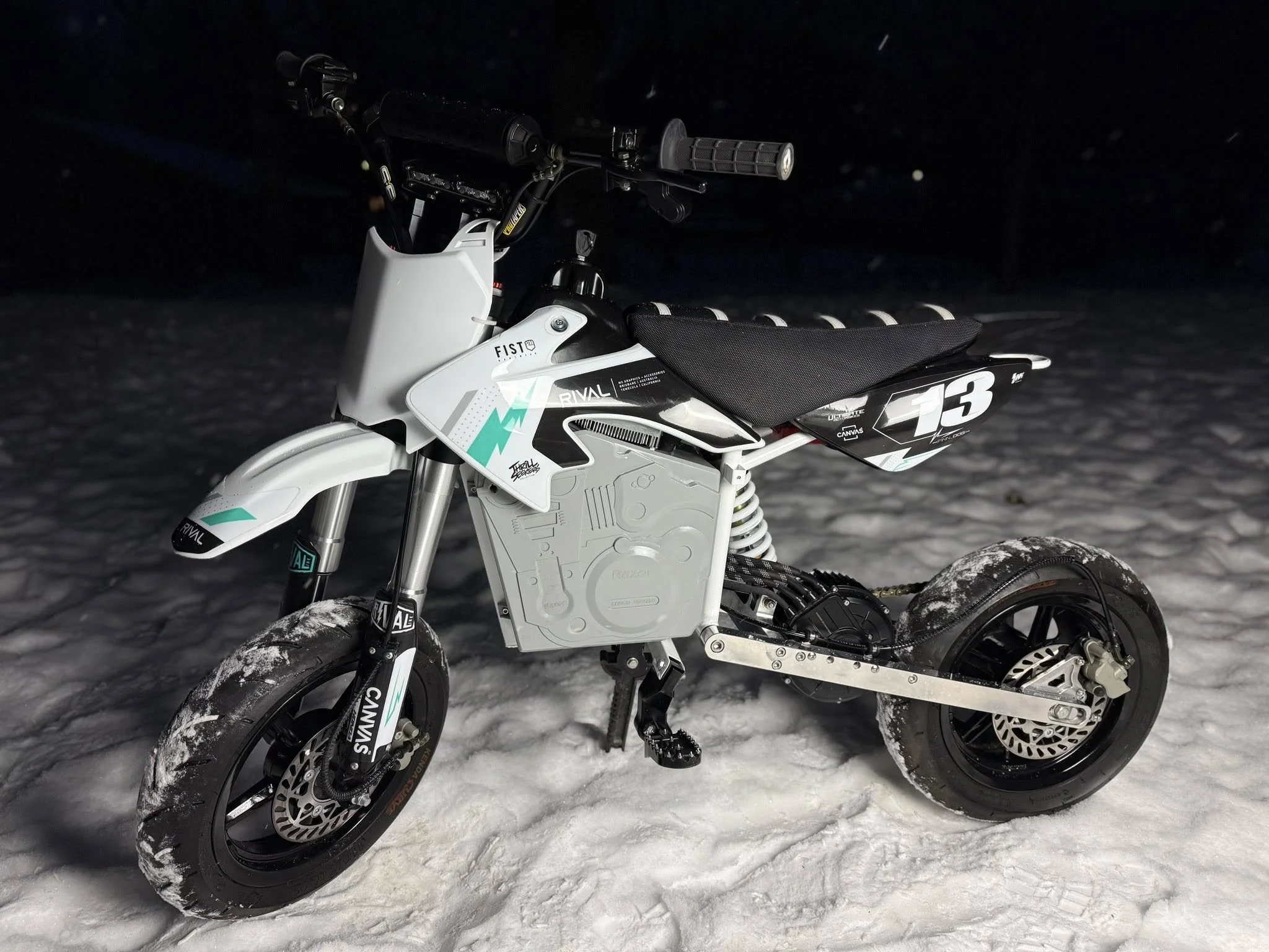 Electric motocross bike on snow at night