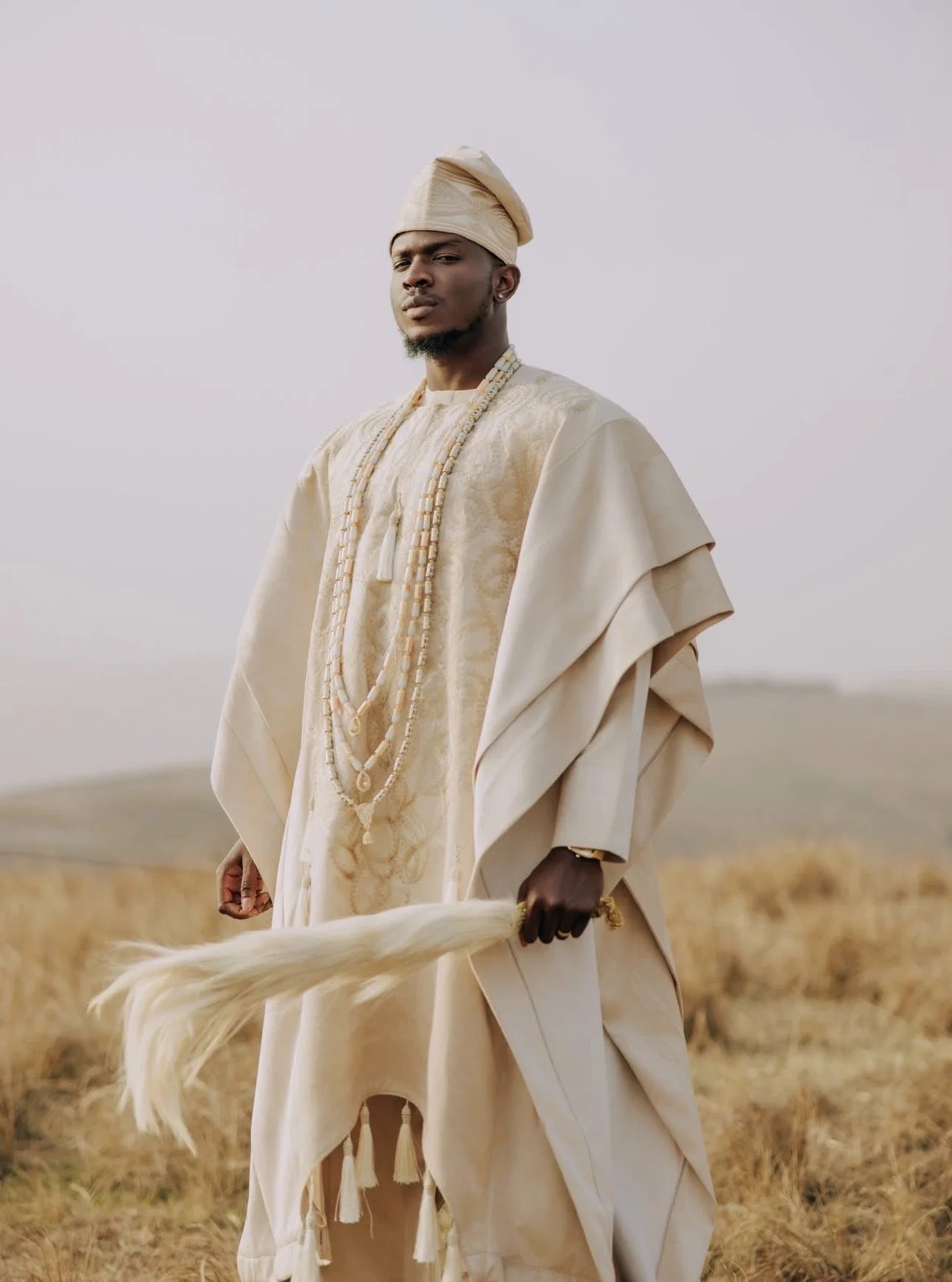 Stacks of fabric adorned with small, shiny beads in various colors including white, pink, black, red, blue, gold, purple, green, beige, and gray.