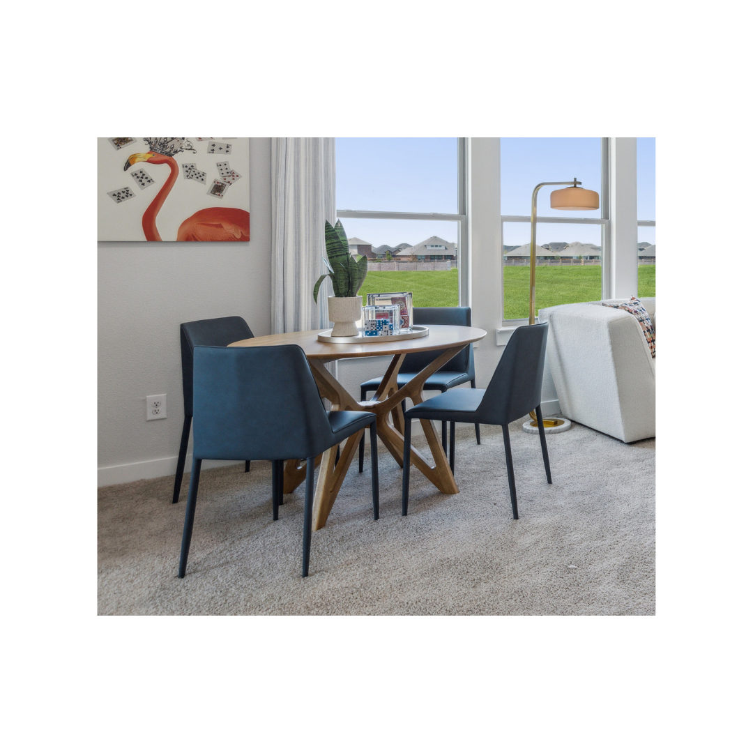 Set of two dining chairs with single color block, made with an iron frame and grey vegan leather shown at a gameroom table in a modern gameroom