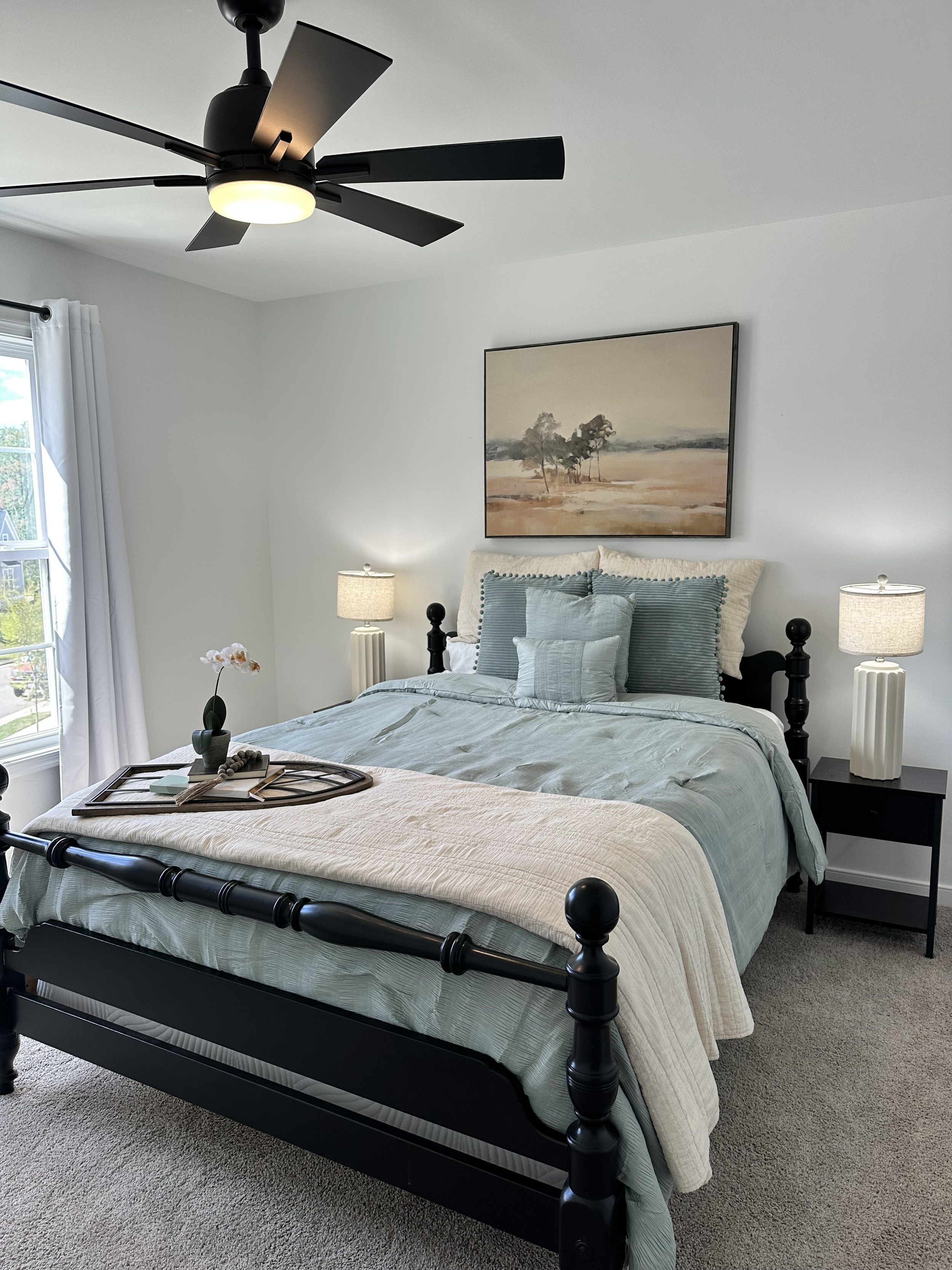 Guest Room After. Neutral art and large lamps make this space inviting for buyers to picture overnight visitors.