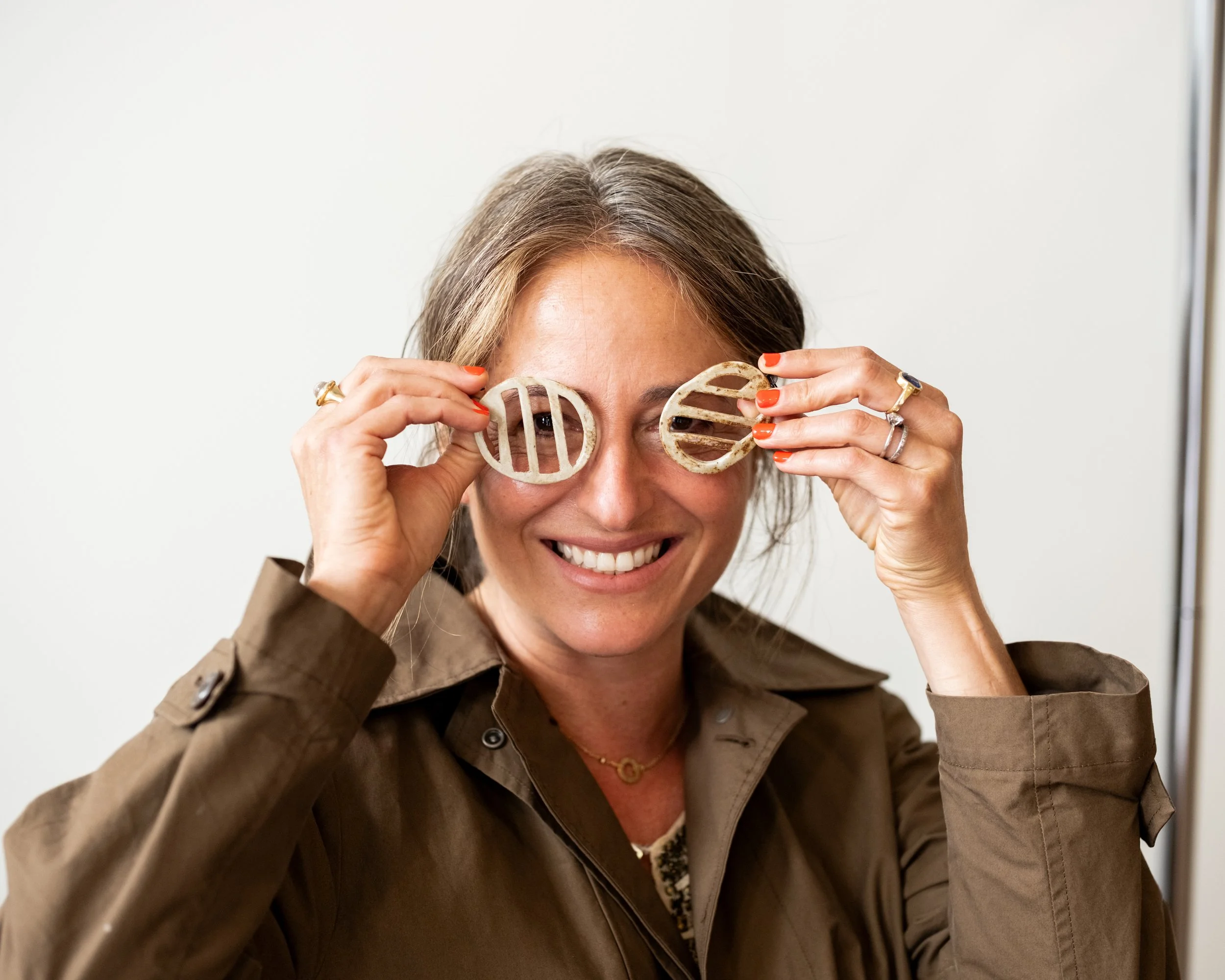 Jess Barzell poses with earrings she made.