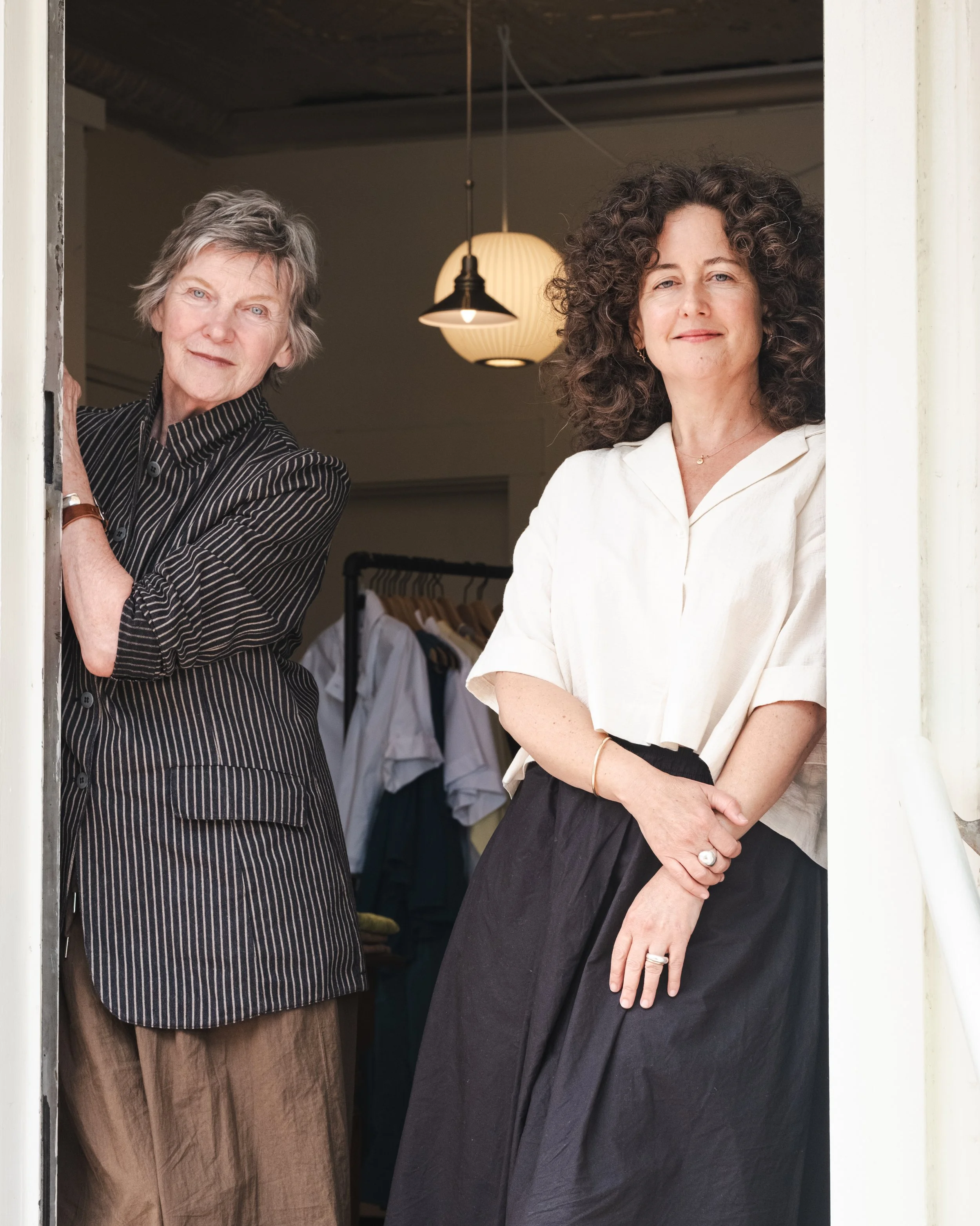 Barbara Corey and Georgia Hill stand in the doorway to their womenswear shop, September.