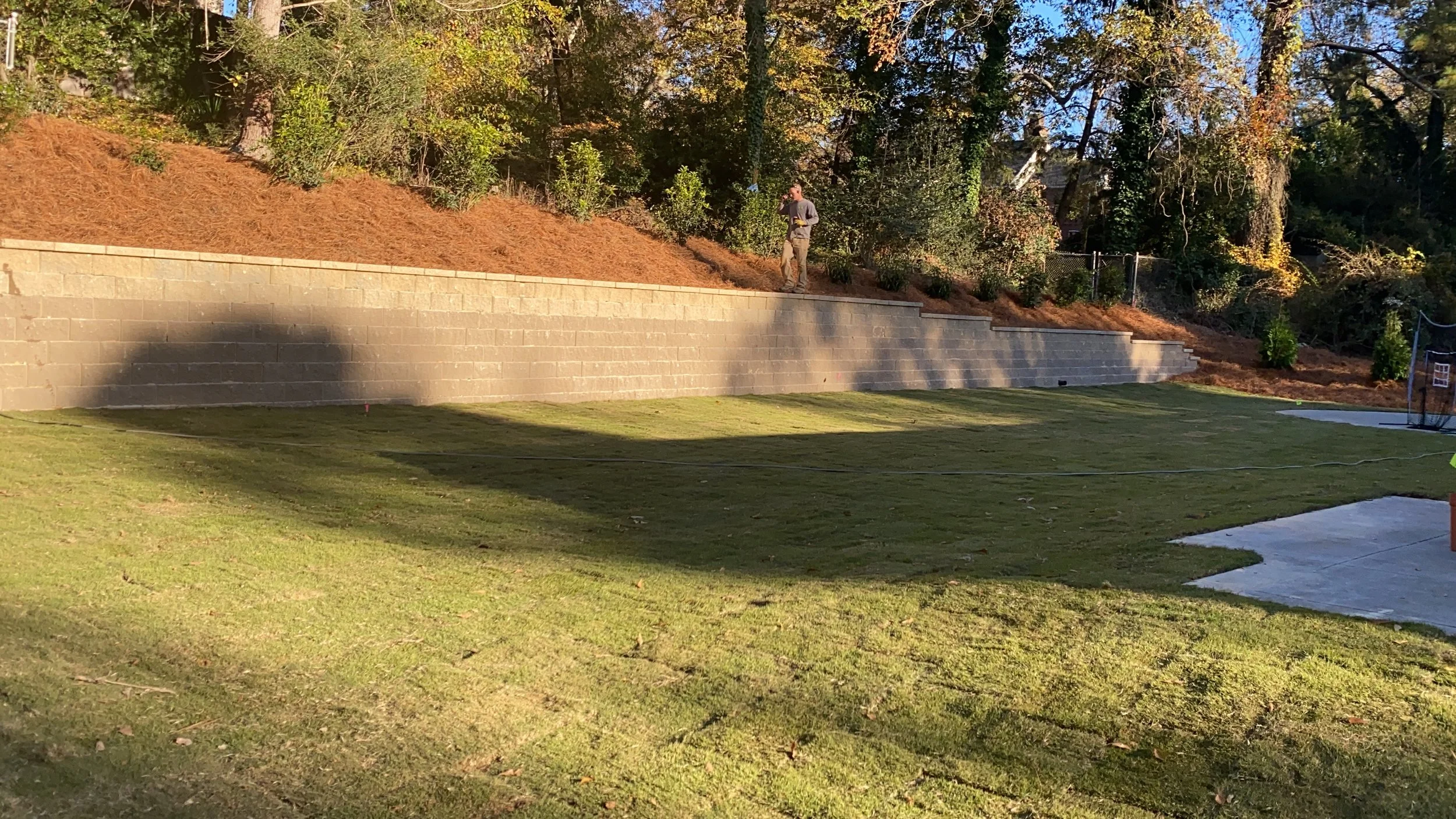 sod artificial turf hughes gainesville ga landscaper landscape design grass lawncare cut grass plants retaining wall