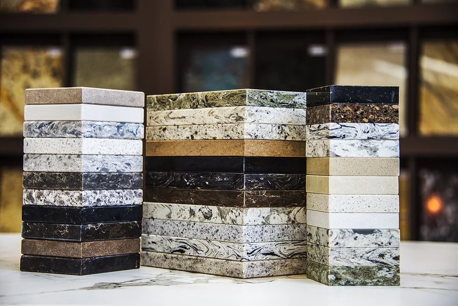 Stacks of countertop material samples displayed in a showroom.