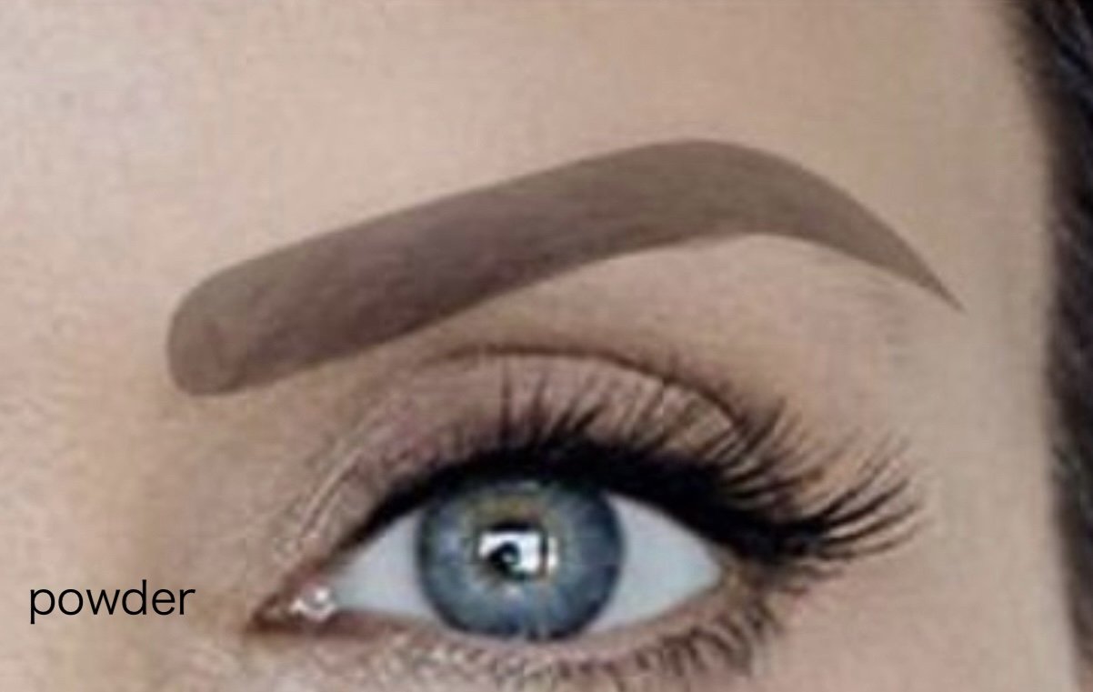 A close-up of an eye showcasing powder brows, with an evenly shaded brow that creates a soft and glamorous appearance.