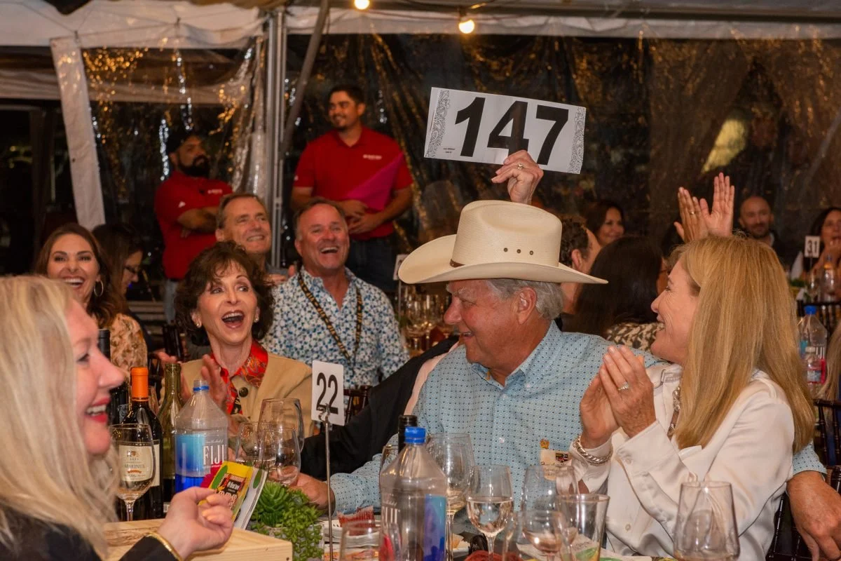 surprised woman in a crowd at an outdoor western event at First Tee 2023 in Salinas, California