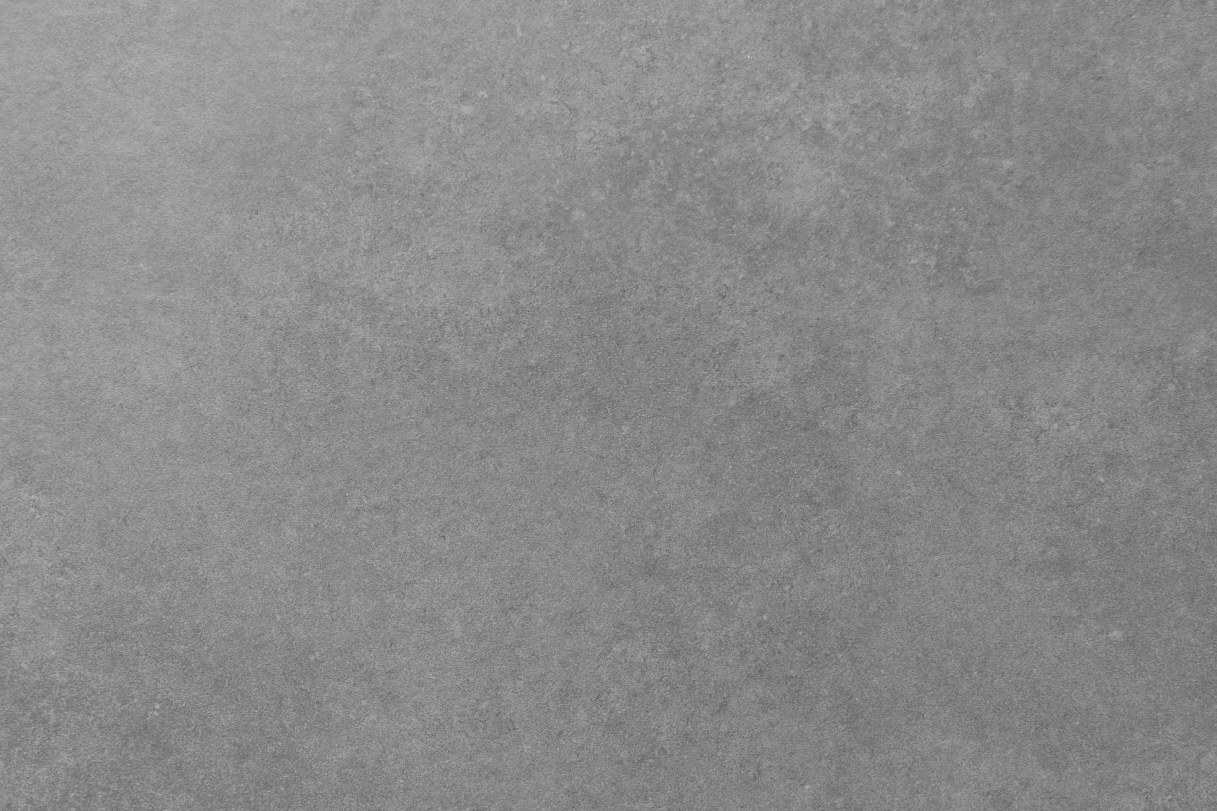 A close-up view of a textured gray surface, possibly of fabric or paper.