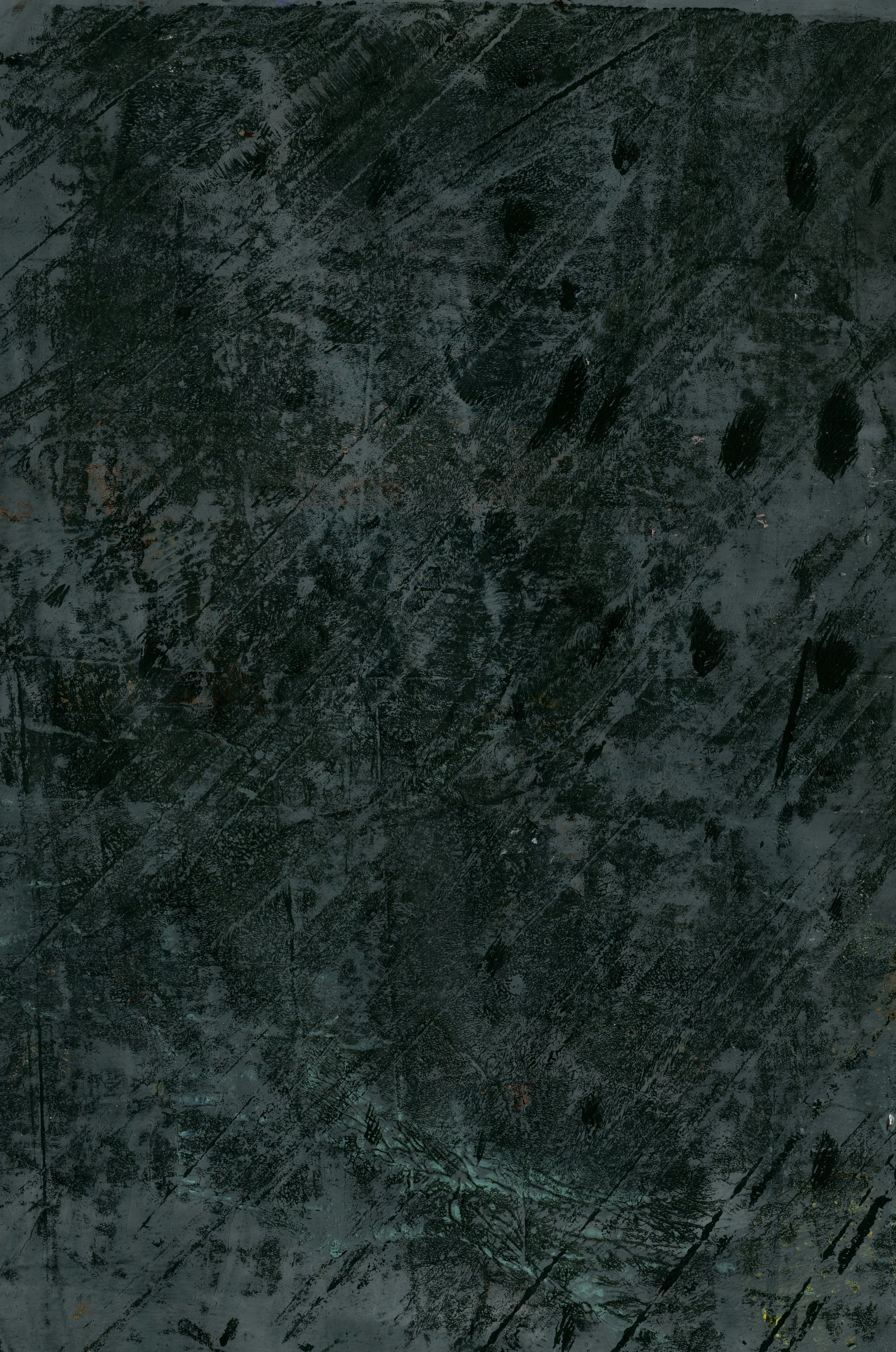 Close-up photograph of a dark, scratched and worn black chalkboard surface.