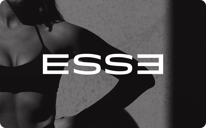 Black and white photo of a woman, with the 'ESSE' logo overlaid in white across her chest.