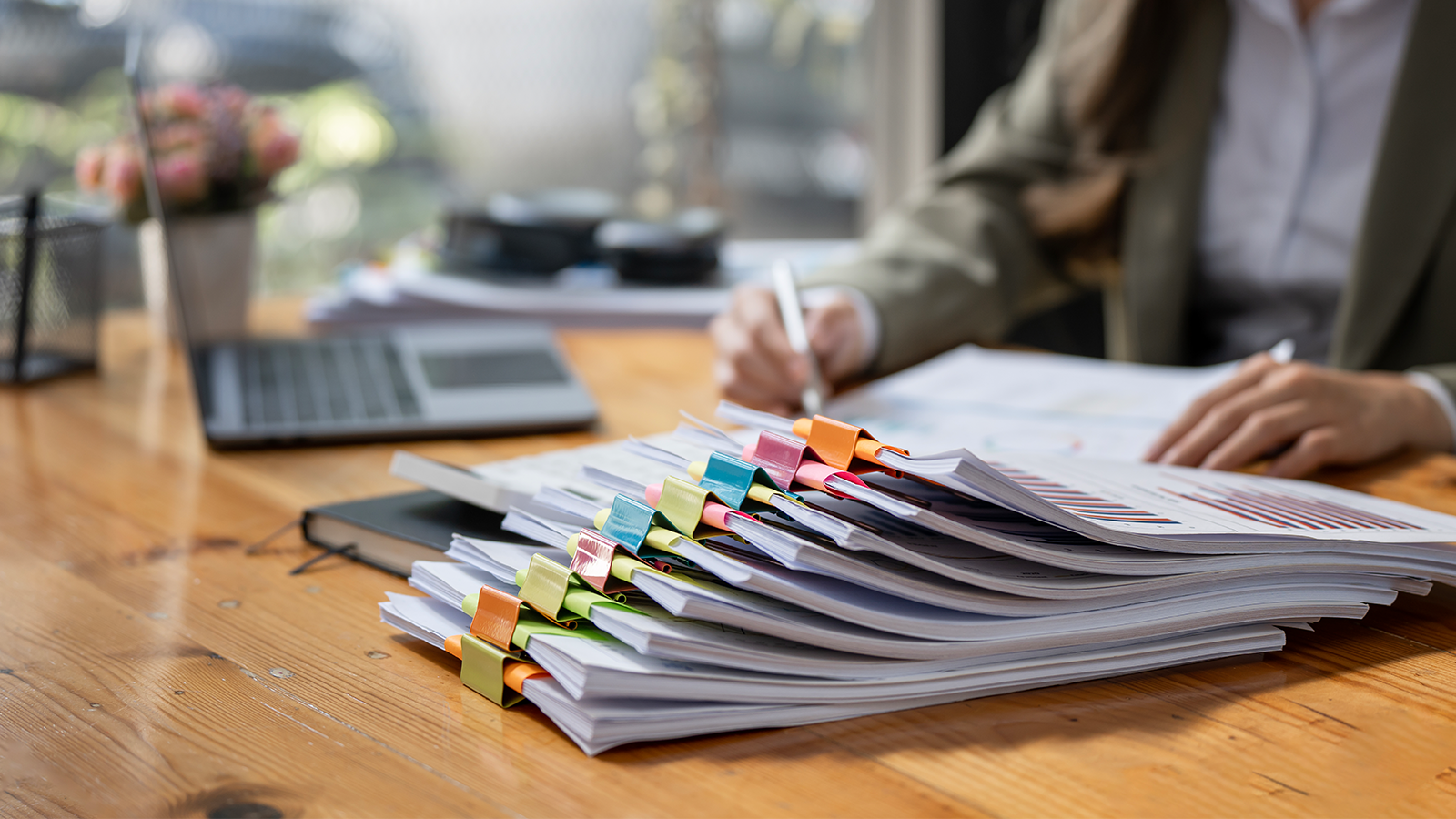 businesswoman-working-in-stacks-of-paper-files-for-2023-11-27-05-06-57-utc.png