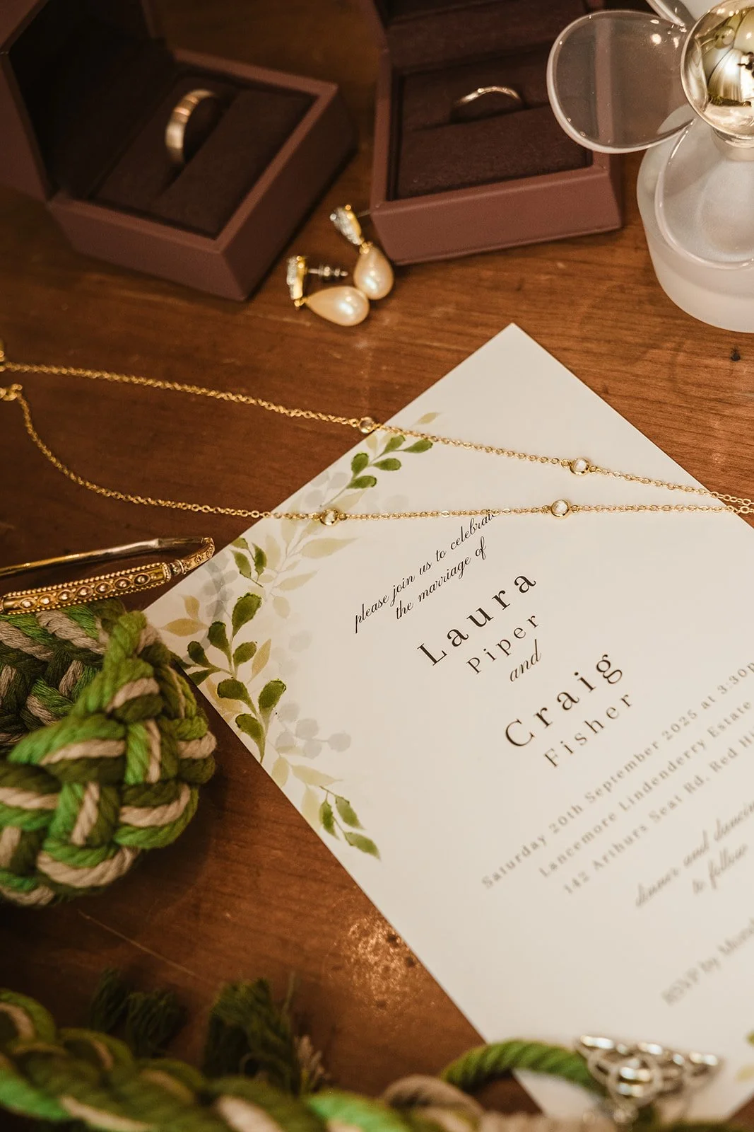wedding detail shot rings flowers flat lay