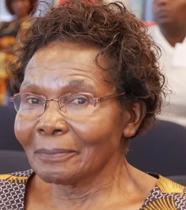 An image of Theresa Sengaaga Ssali smiling at the camera with glasses.