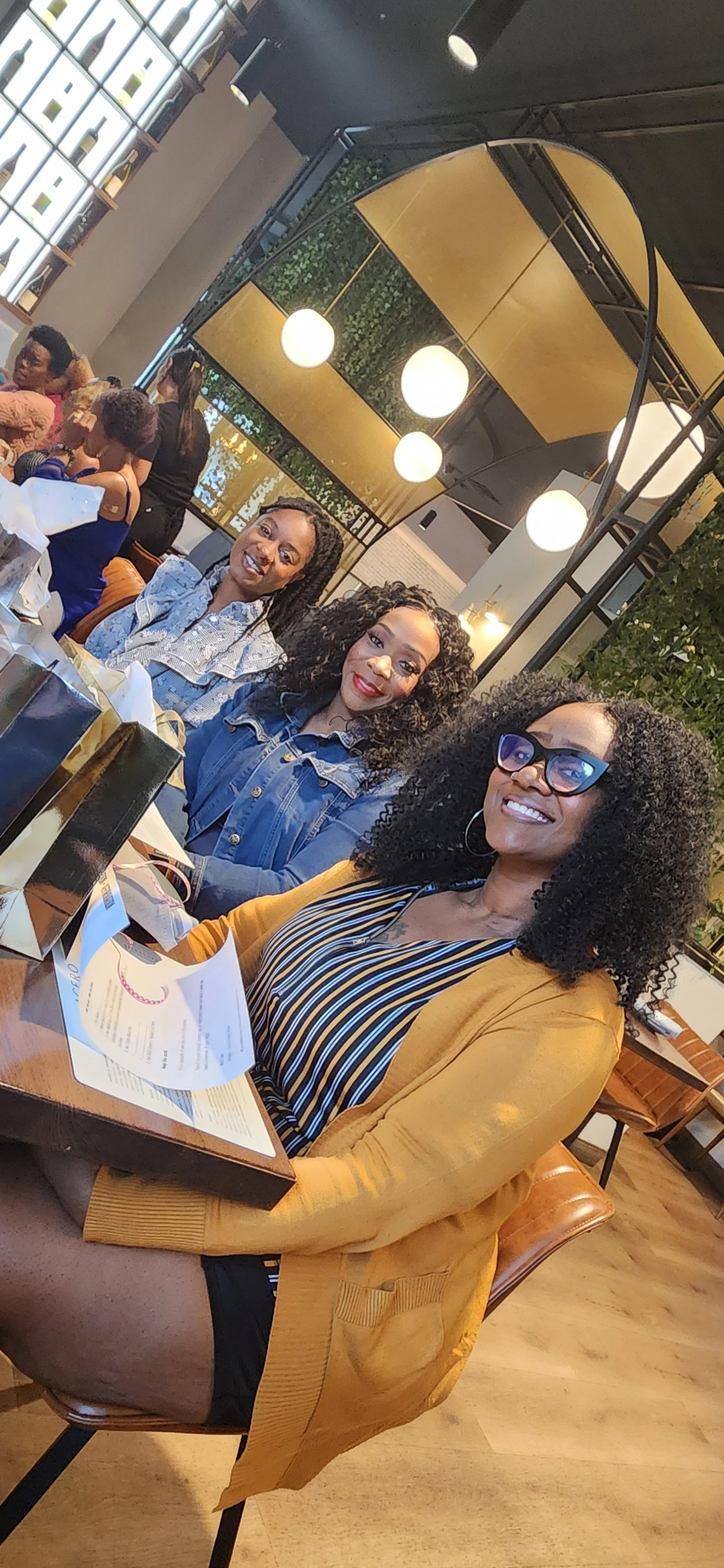 Sisters laughing together over lunch at a Sistas Who Lunch gathering in the Treasure Valley
