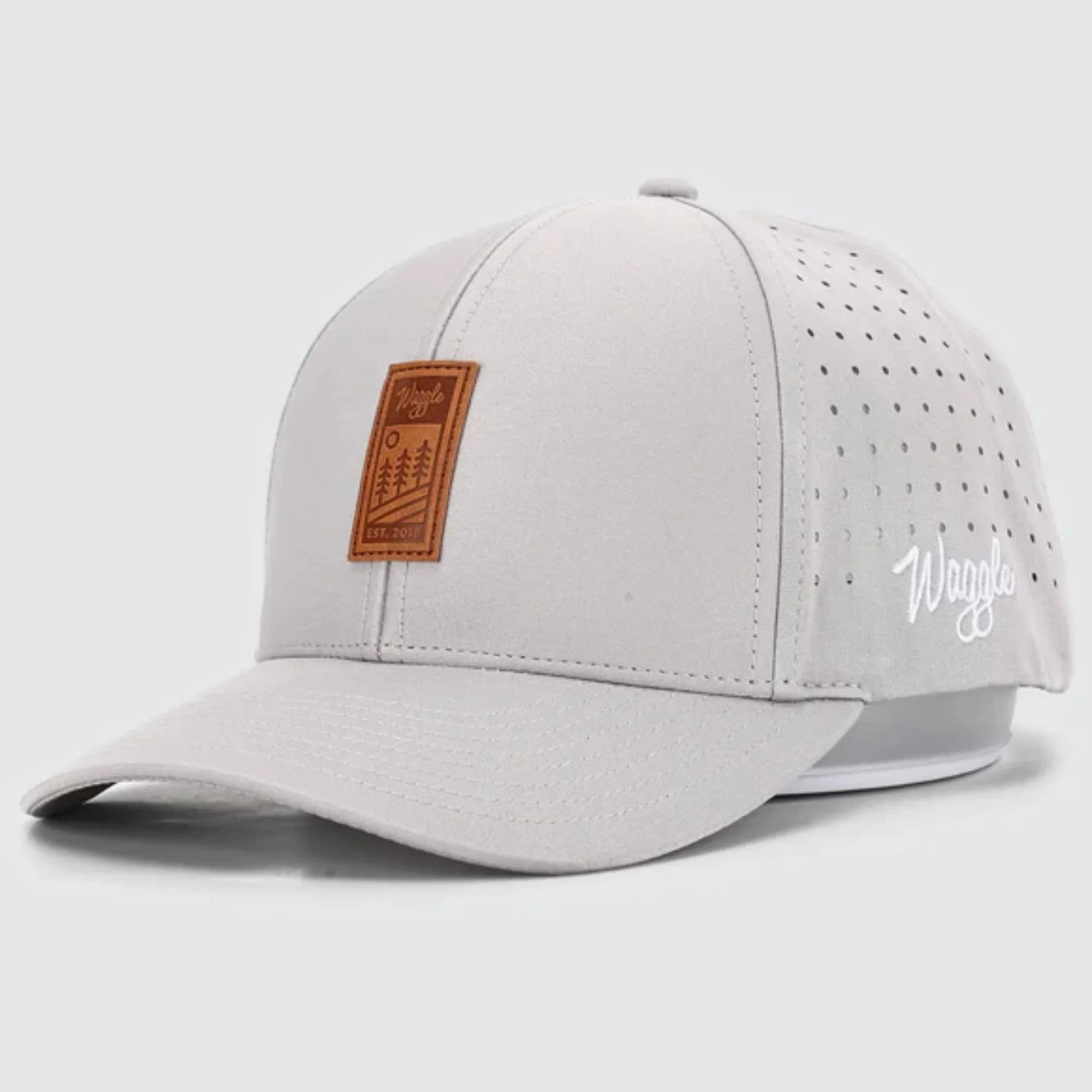 Waggle Heritage hat, angled front view, light grey, showing leather patch and Waggle logo