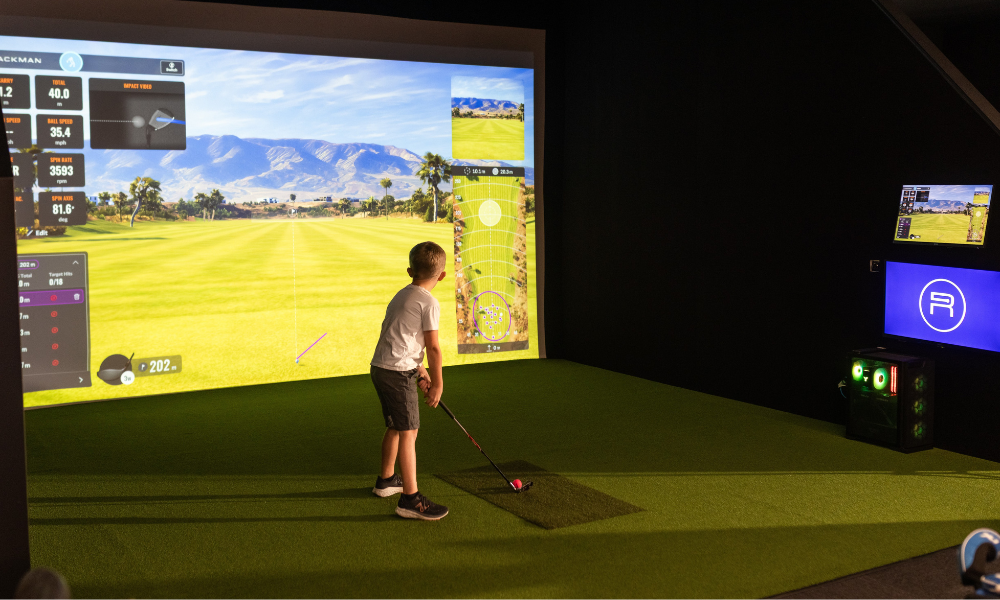 Kids using TrackMan simulators at The Range, Christchurch’s indoor golf centre