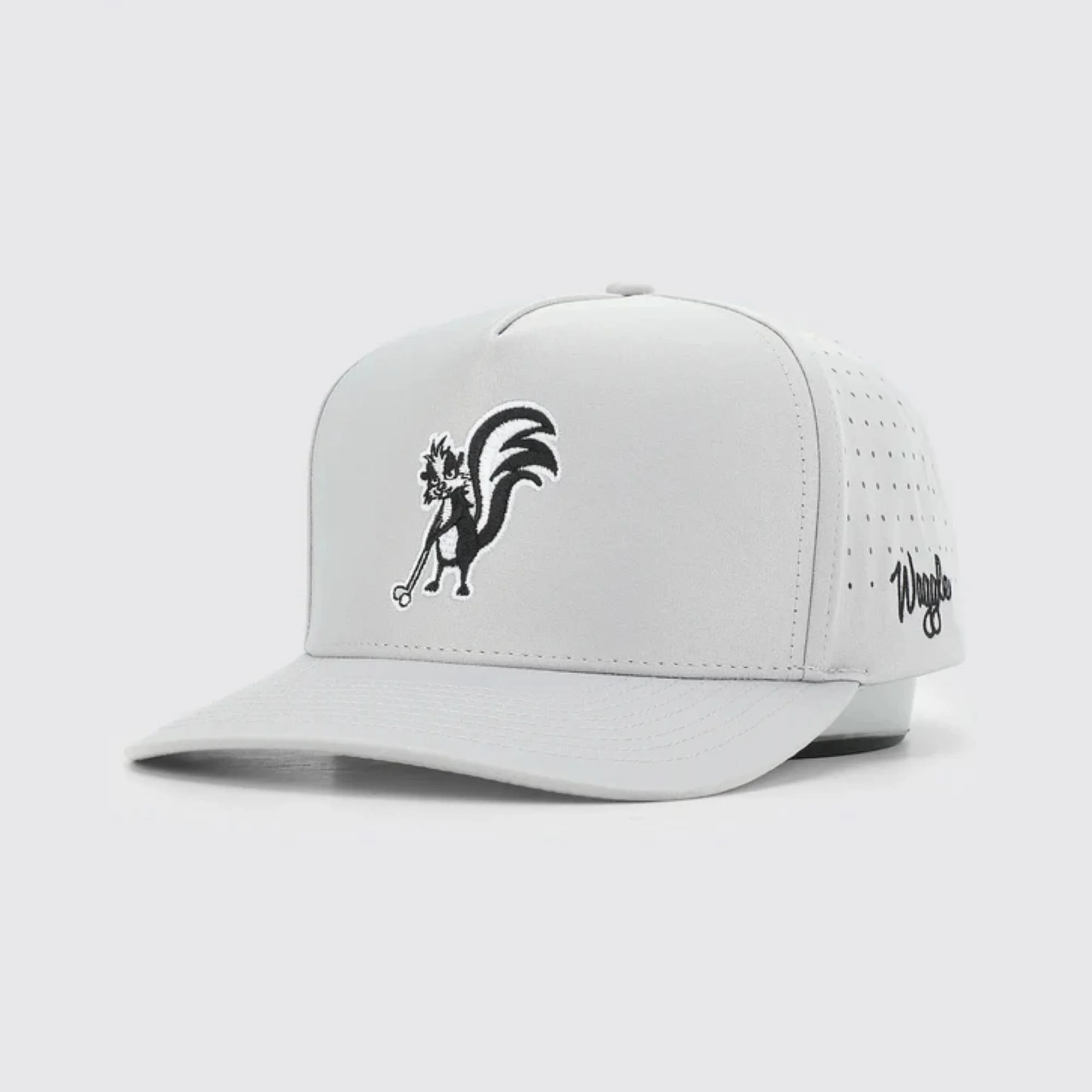 Waggle Stinkin' It Up hat, light grey, angled front view showing skunk embroidery detail