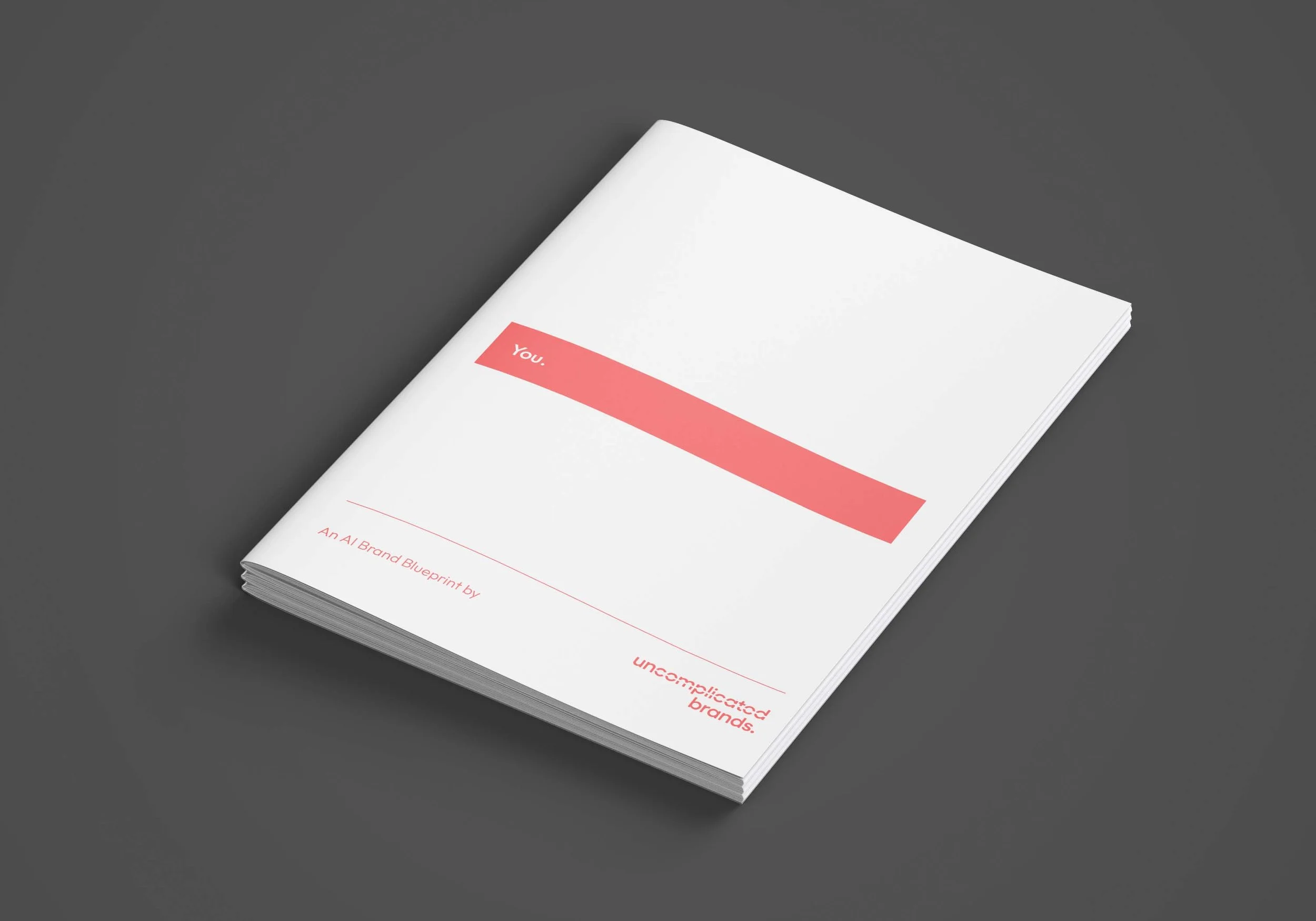 A white booklet with pink highlights titled 'You.' on a dark gray background. The subtitle reads 'An AI Brand Blueprint by uncomplicate brands.'