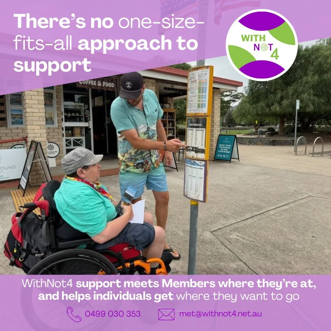 A support worker stands beside a bus stop timetable pointing out information to a person using a wheelchair. They are outside near a café and trees, appearing to discuss how to use the bus timetable. Overlaid text reads “There’s no one-size-fits-all 