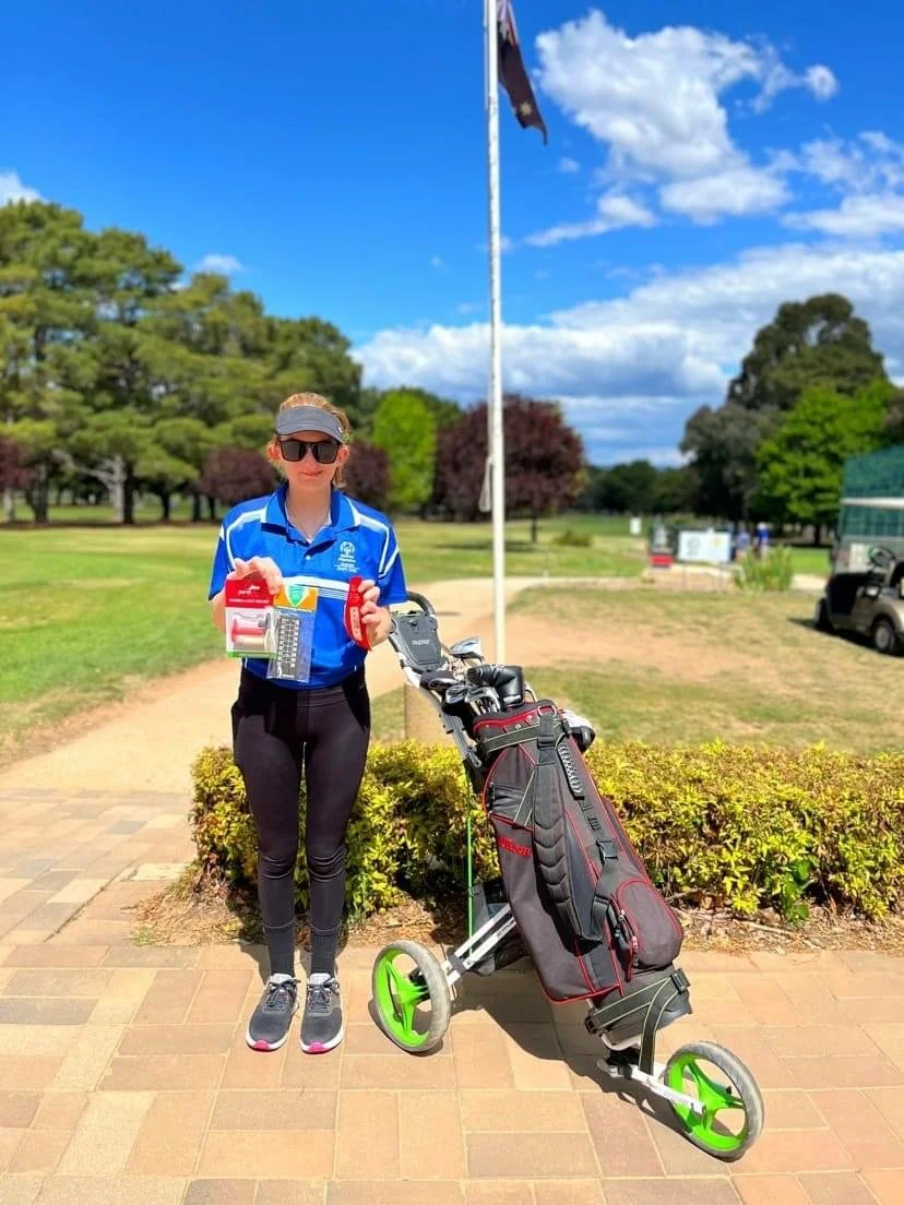 Hannah w Golf Clubs.jpeg