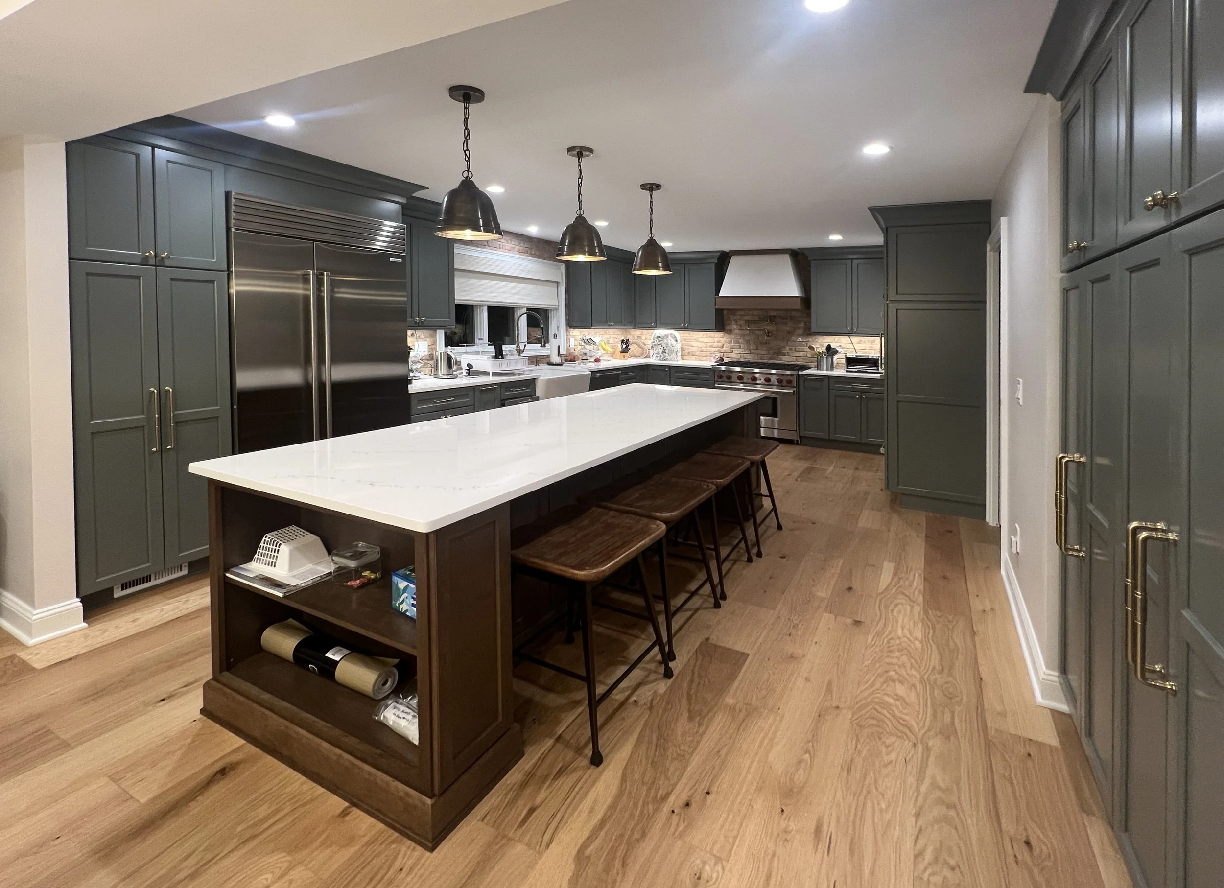 Kitchen with green cabinets and center island