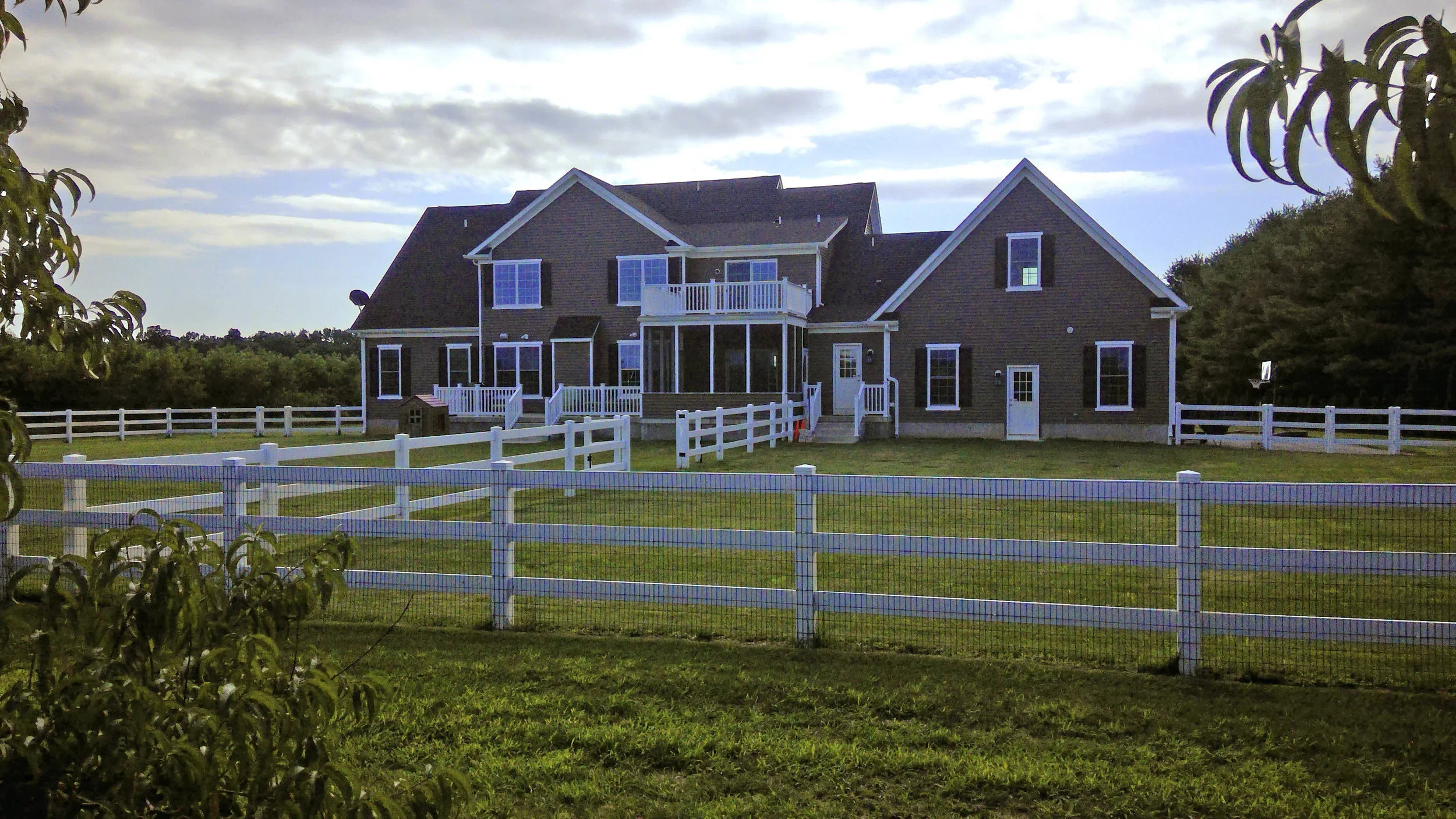 Rear of finished house with second floor balcony