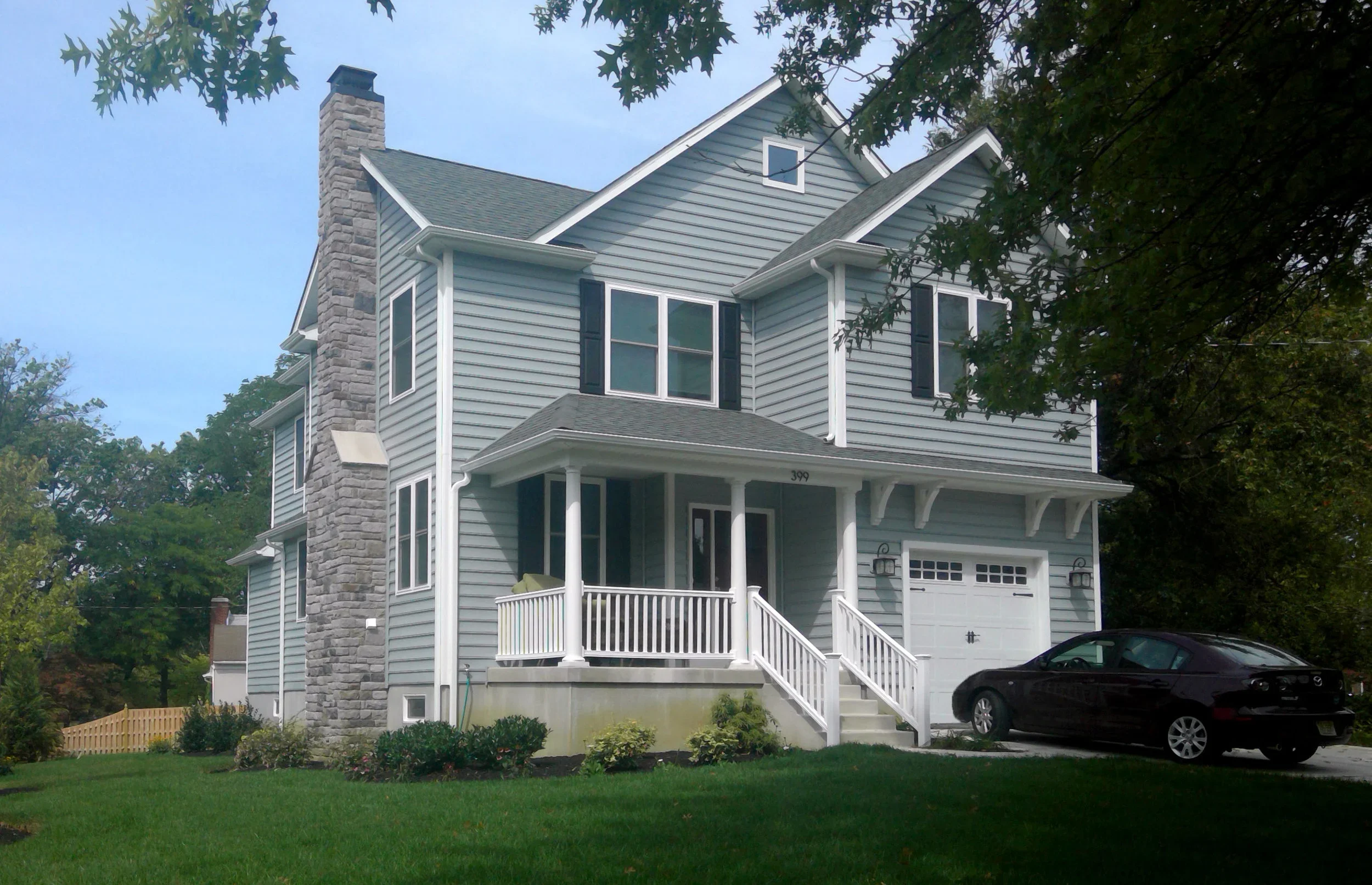 Front left of two-story house stone chimney