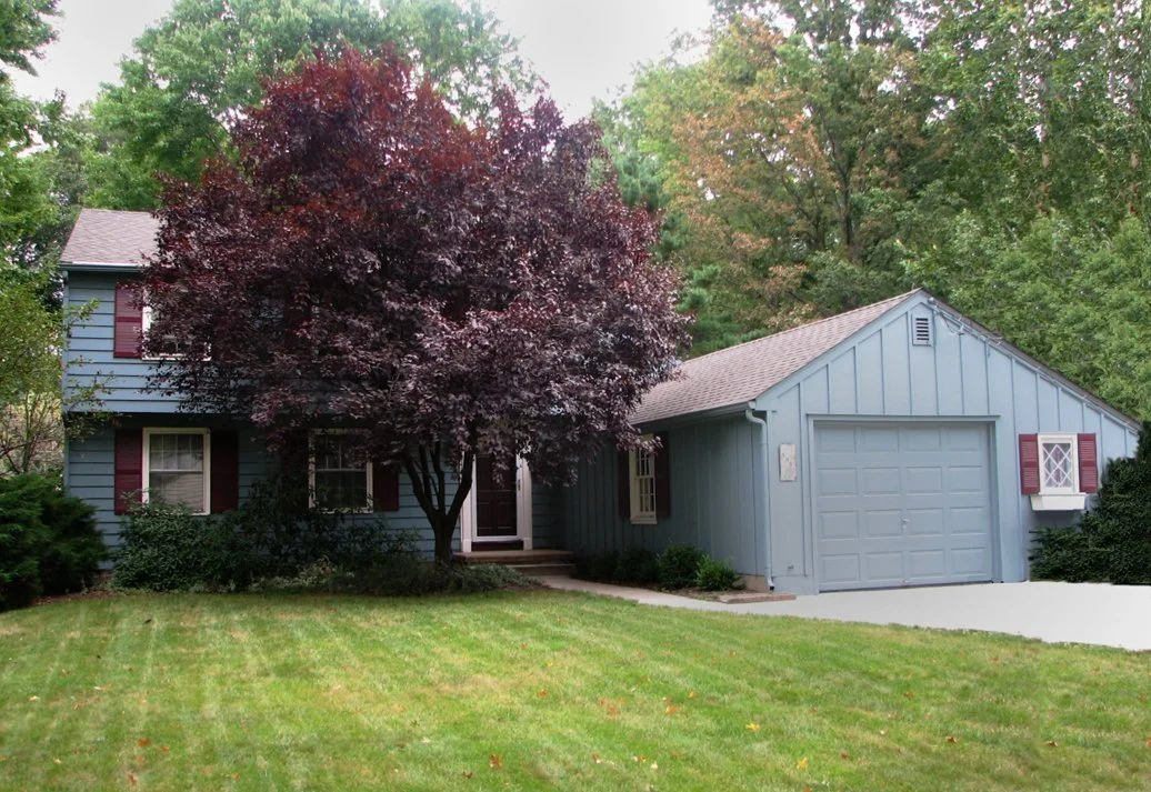 Existing blue house with red shutters prior to renovation