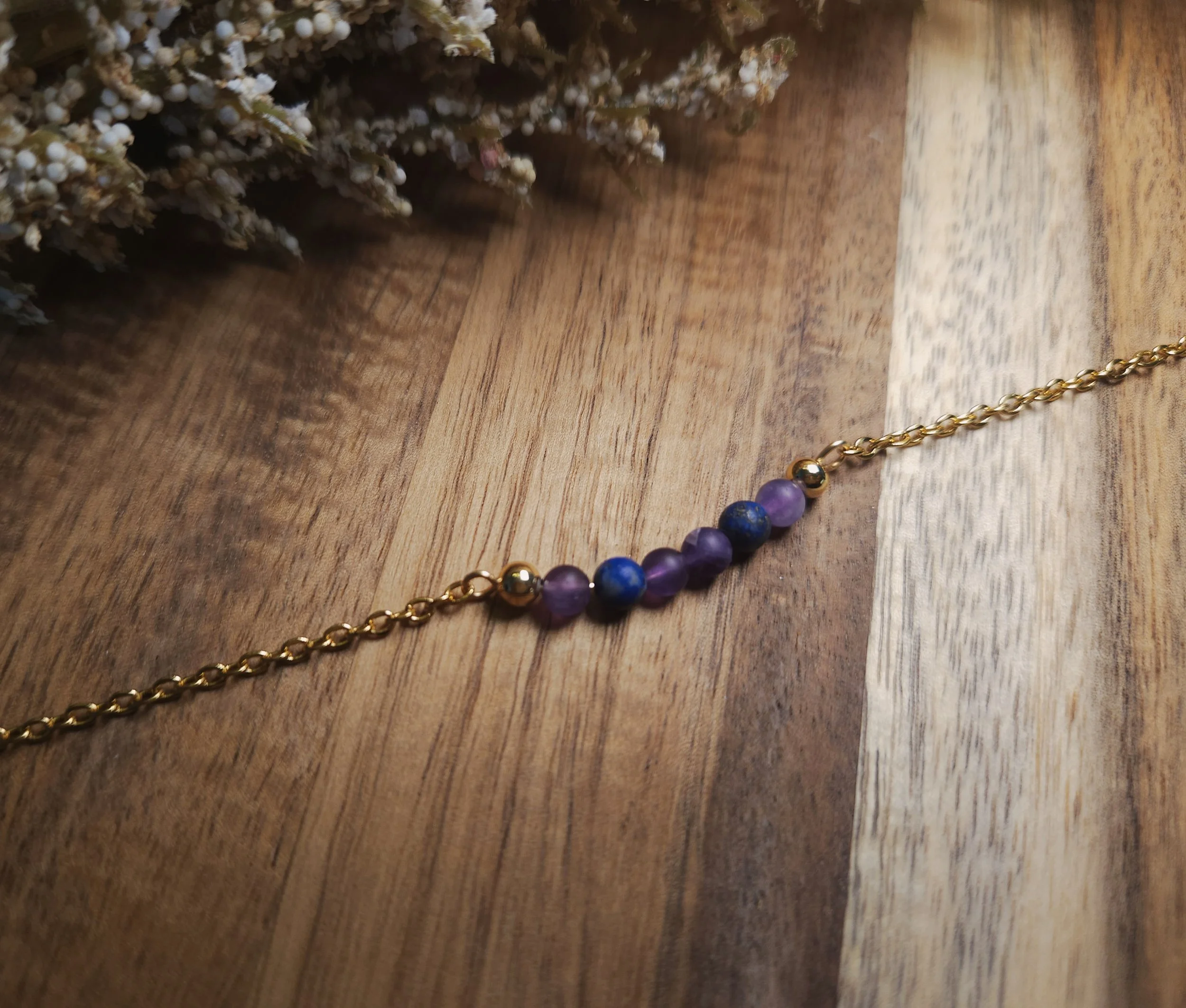 gold, blue, and purple delicate bracelet