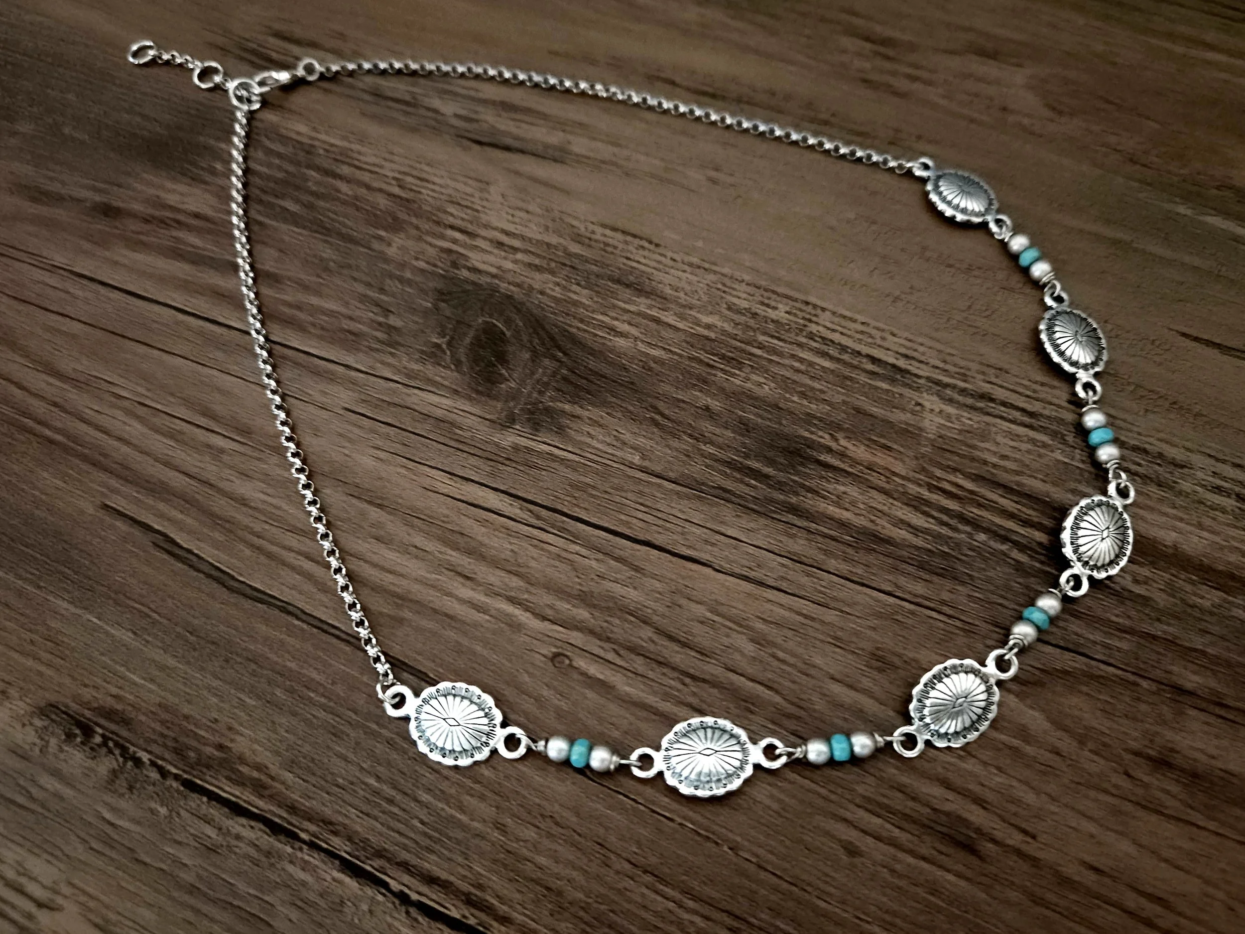 Our bestselling bracelet — now available as a necklace. Featuring turquoise-inspired beads, western concho accents, and a 2.5mm silver-plated rolo chain, this necklace measures 18" total length including the conchos and chain, plus a 1" extender for 